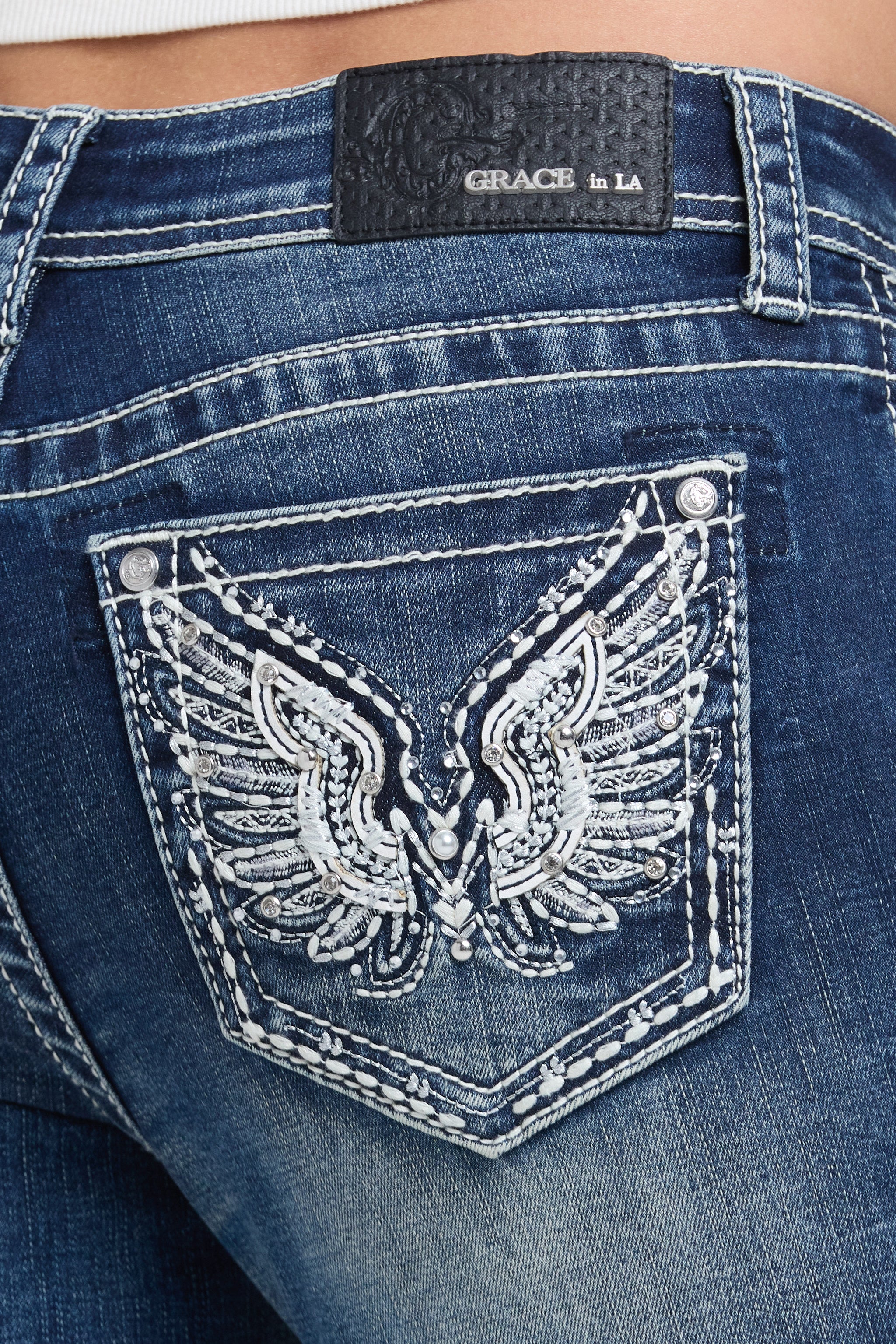 Grace in LA women's medium wash bootcut jeans in a slim western silhouette with wing embroidery