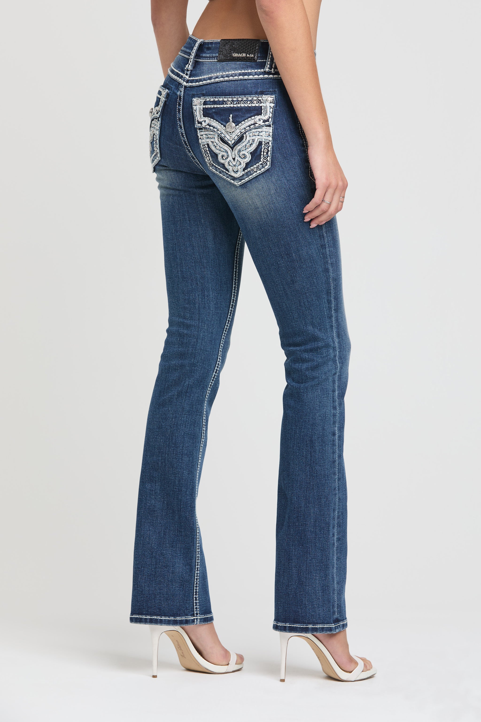 Grace in LA womens bootcut jeans in dark with copper sailor button front pocket detailing.