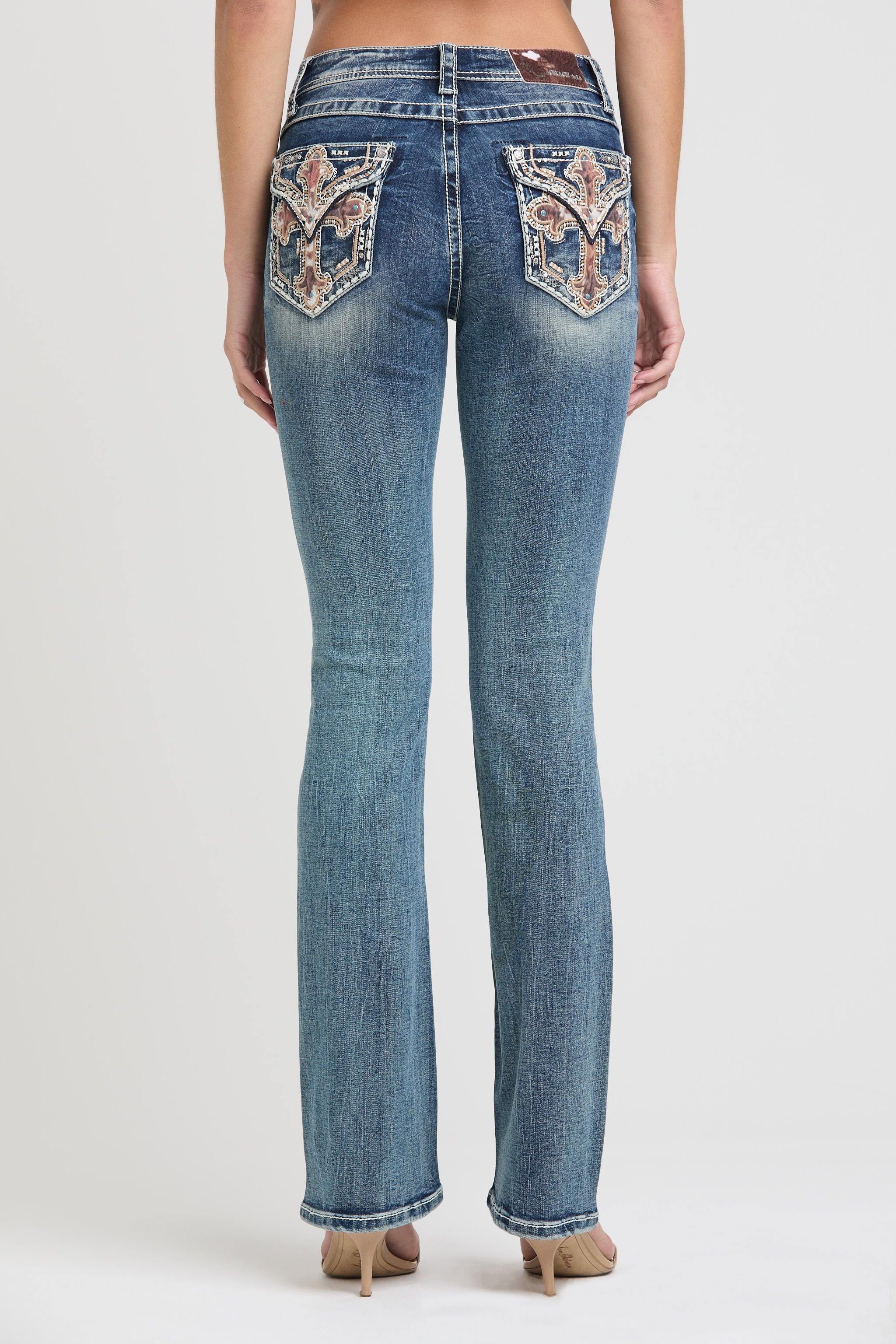 Grace in LA womens bootcut jeans in a medium featuring a full rear view with symmetrical crystal-embellished longhorn embroidery on both back pockets.