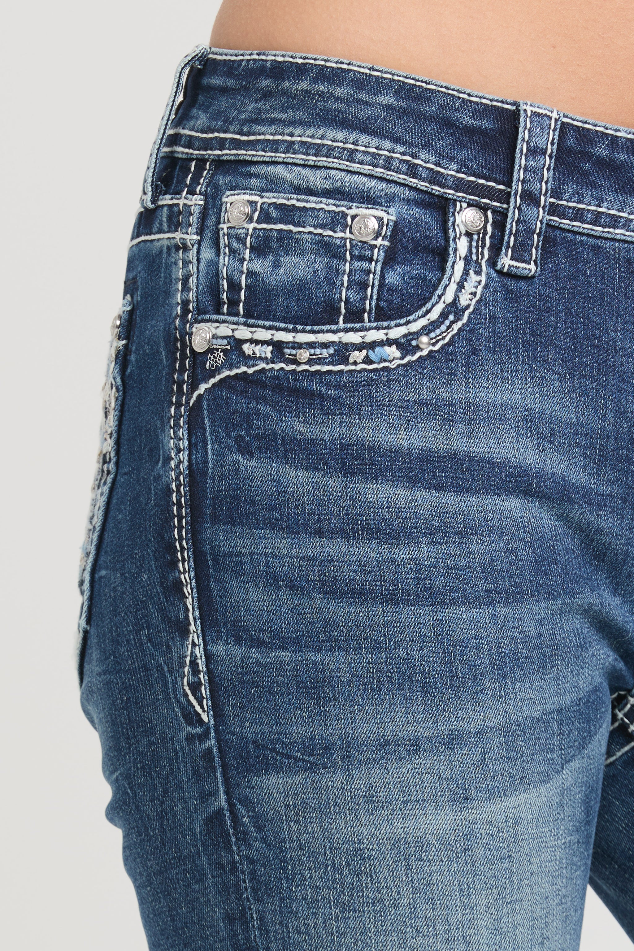 Grace in LA womens bootcut jeans featuring a medium blue with subtle whiskering and decorative white stitching on the front coin pocket.