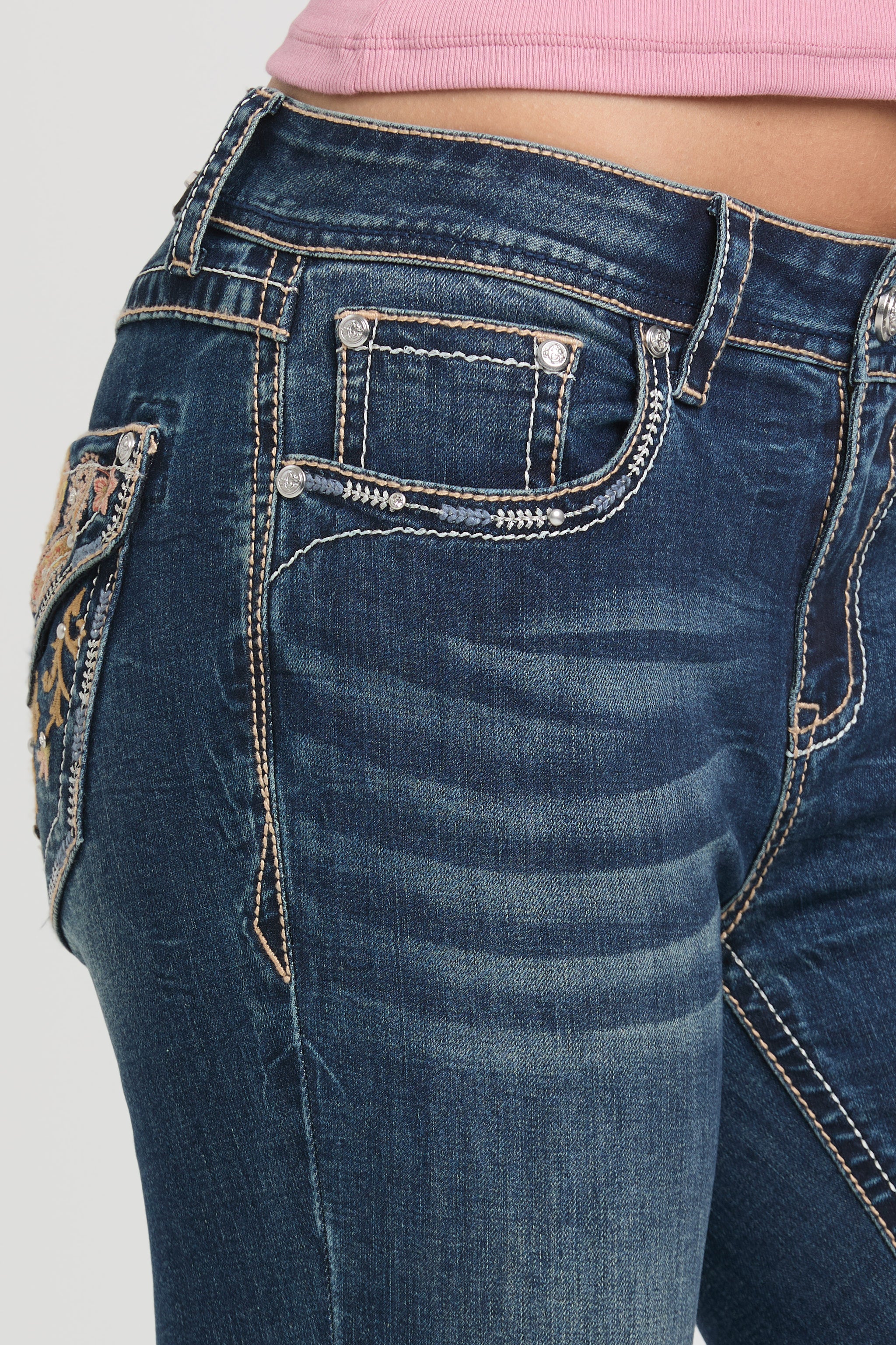 Close-up of Grace in LA embroidered jeans for women featuring western-style decorative stitching and rhinestone pocket details.