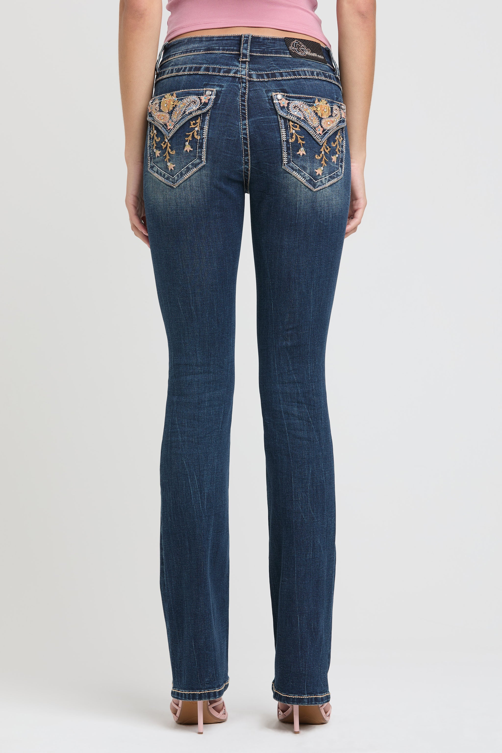 Grace in LA womens bootcut jeans with intricate floral embroidery and rhinestone embellishments on back pockets.