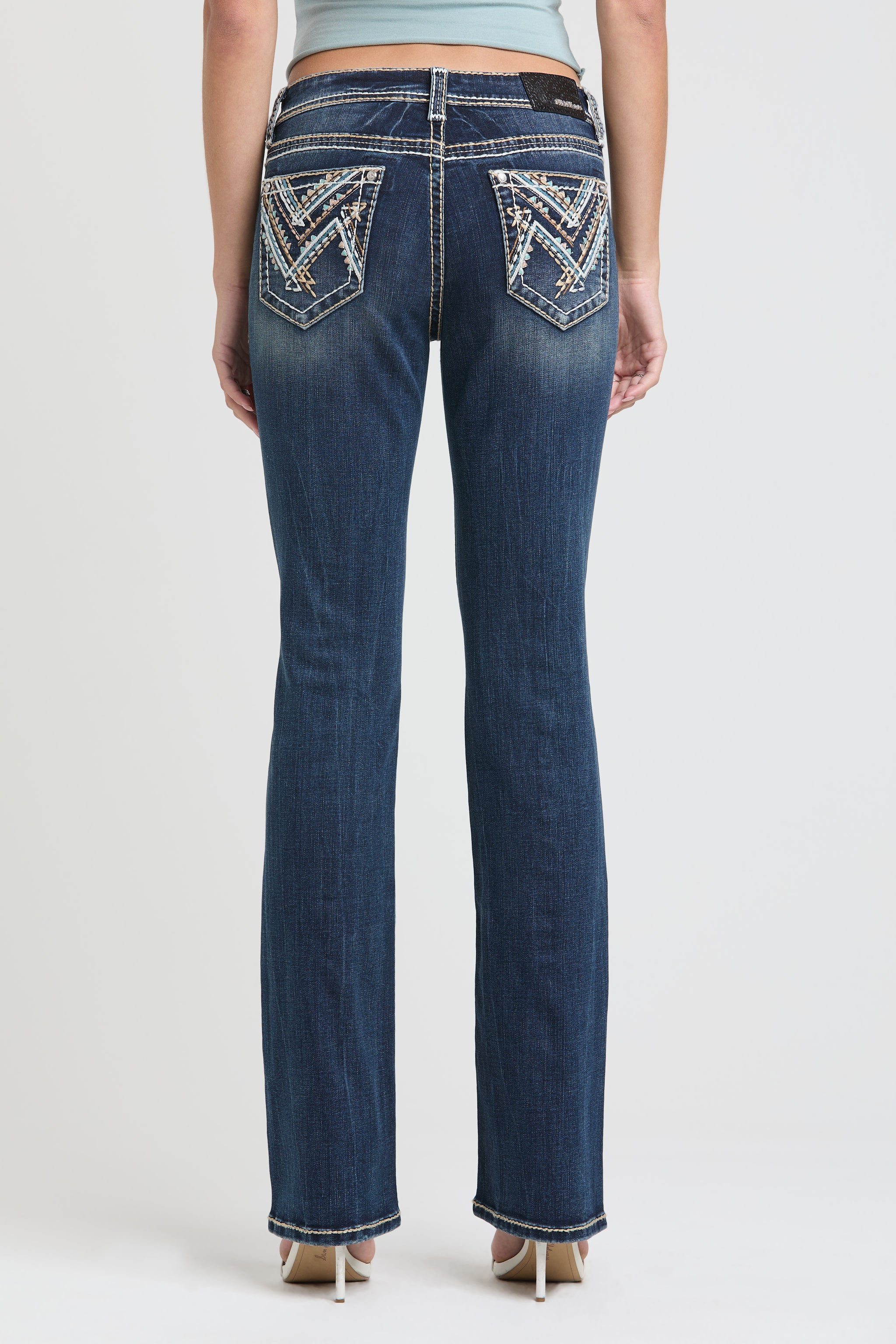 Womens bootcut jeans Rear view of Grace in LA showing symmetrical geometric Aztec embroidery on the back pockets.