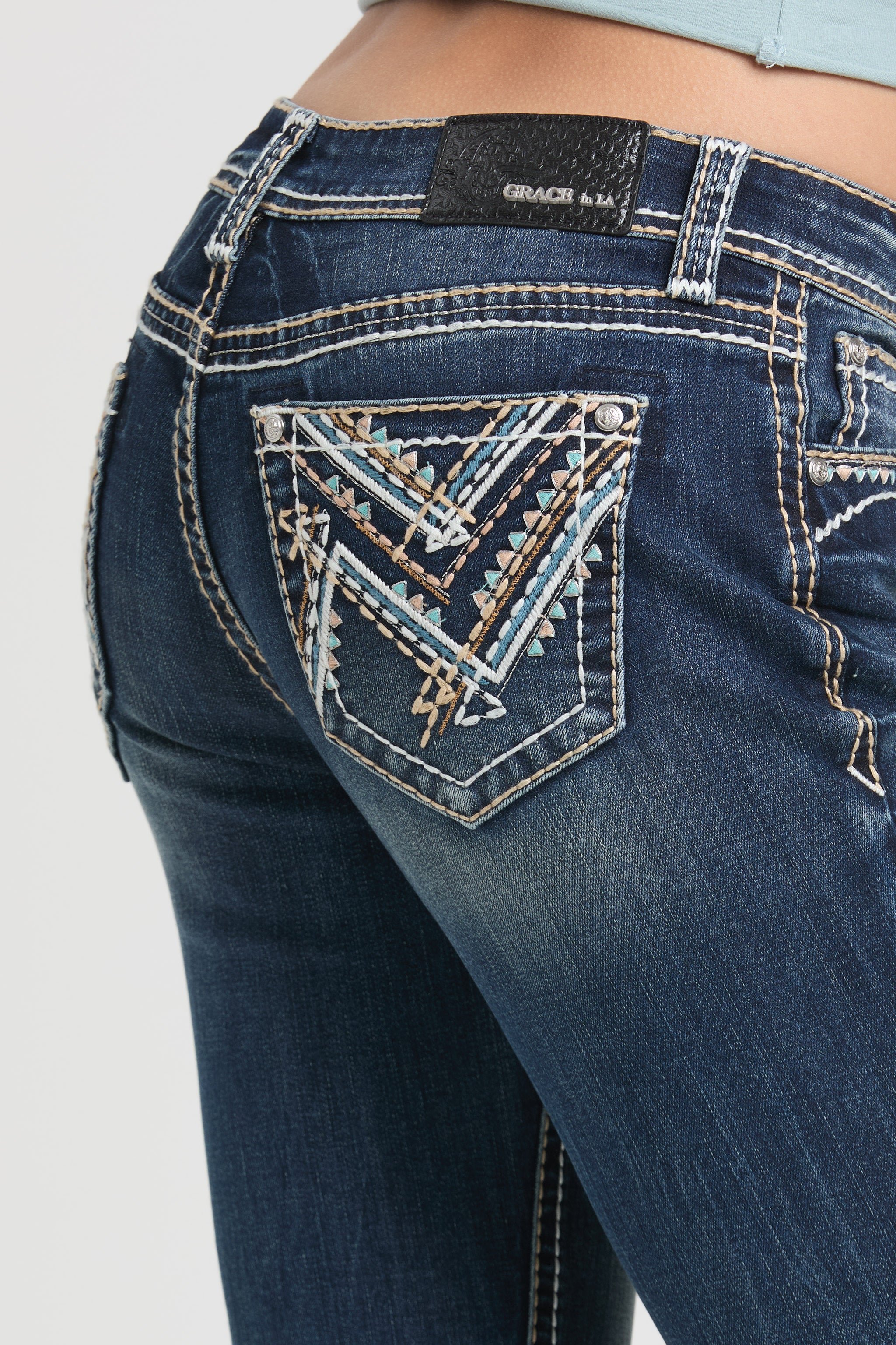 Close-up of a back pocket featuring an intricate geometric Aztec-style embroidery on Grace in LA womens bootcut jeans.