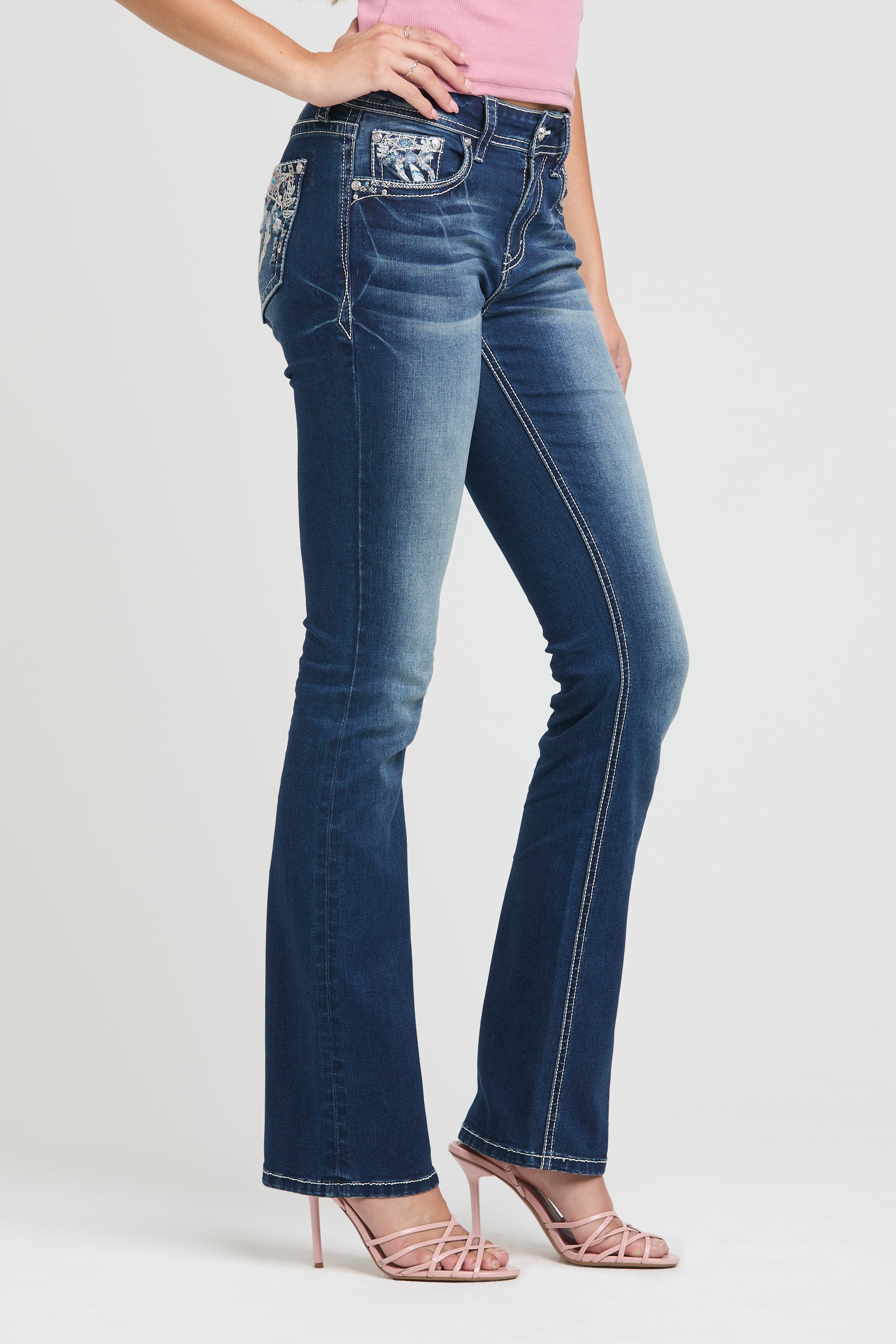 Grace in LA embroidered jeans women featuring a western horseshoe motif on the back pocket with white floral embroidery and light pink rhinestone accents.