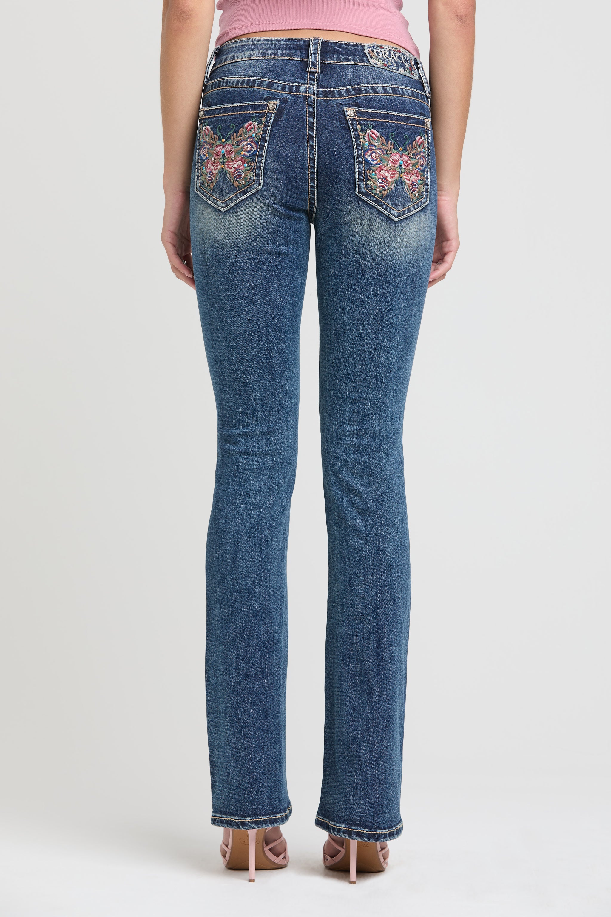 Womens bootcut jeans full straight back view showcasing symmetrical butterfly pocket embroidery on Grace in LA.