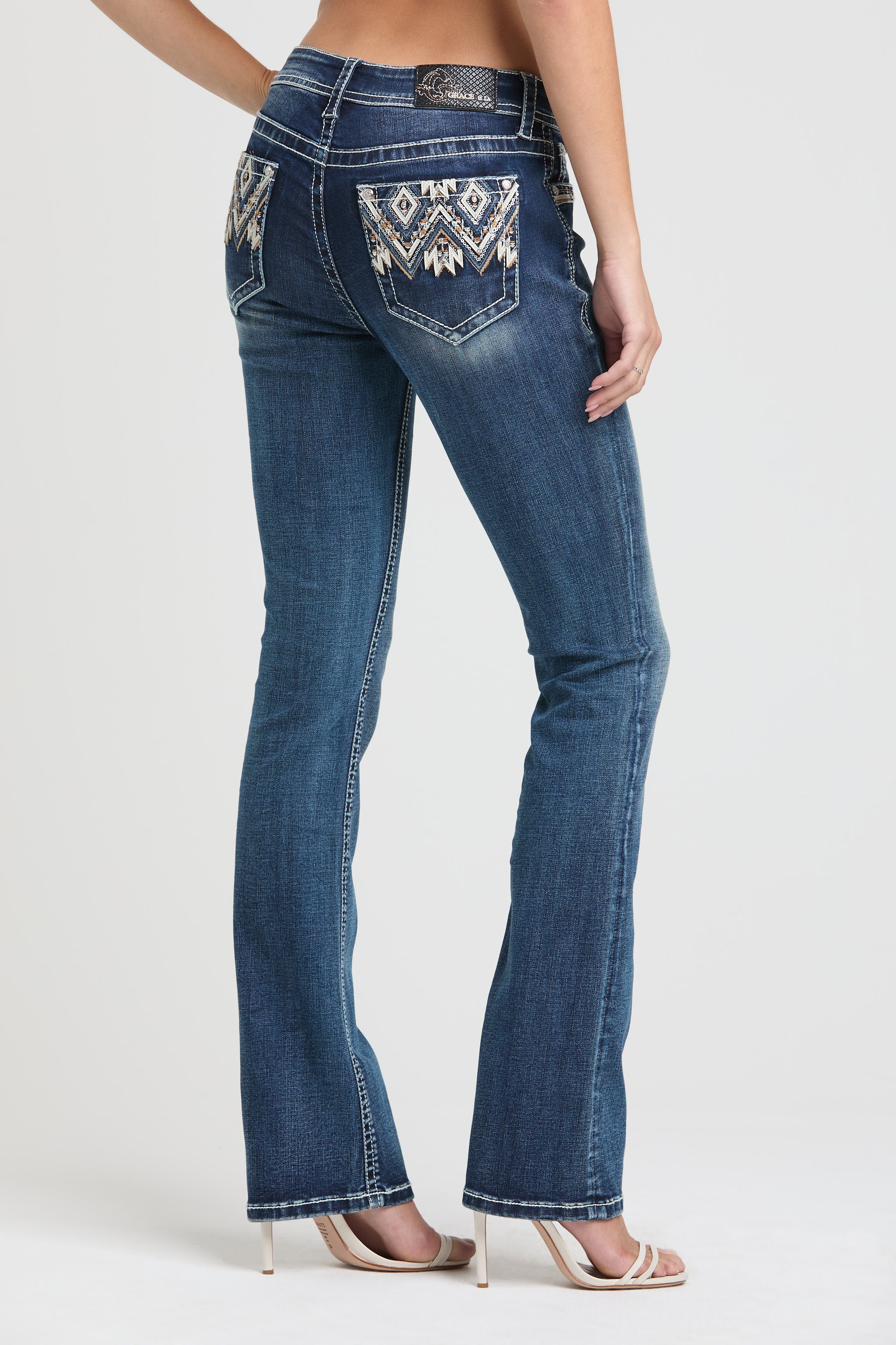 Grace in LA flare jeans for women with western embroidered diamond patterns on the back pockets.