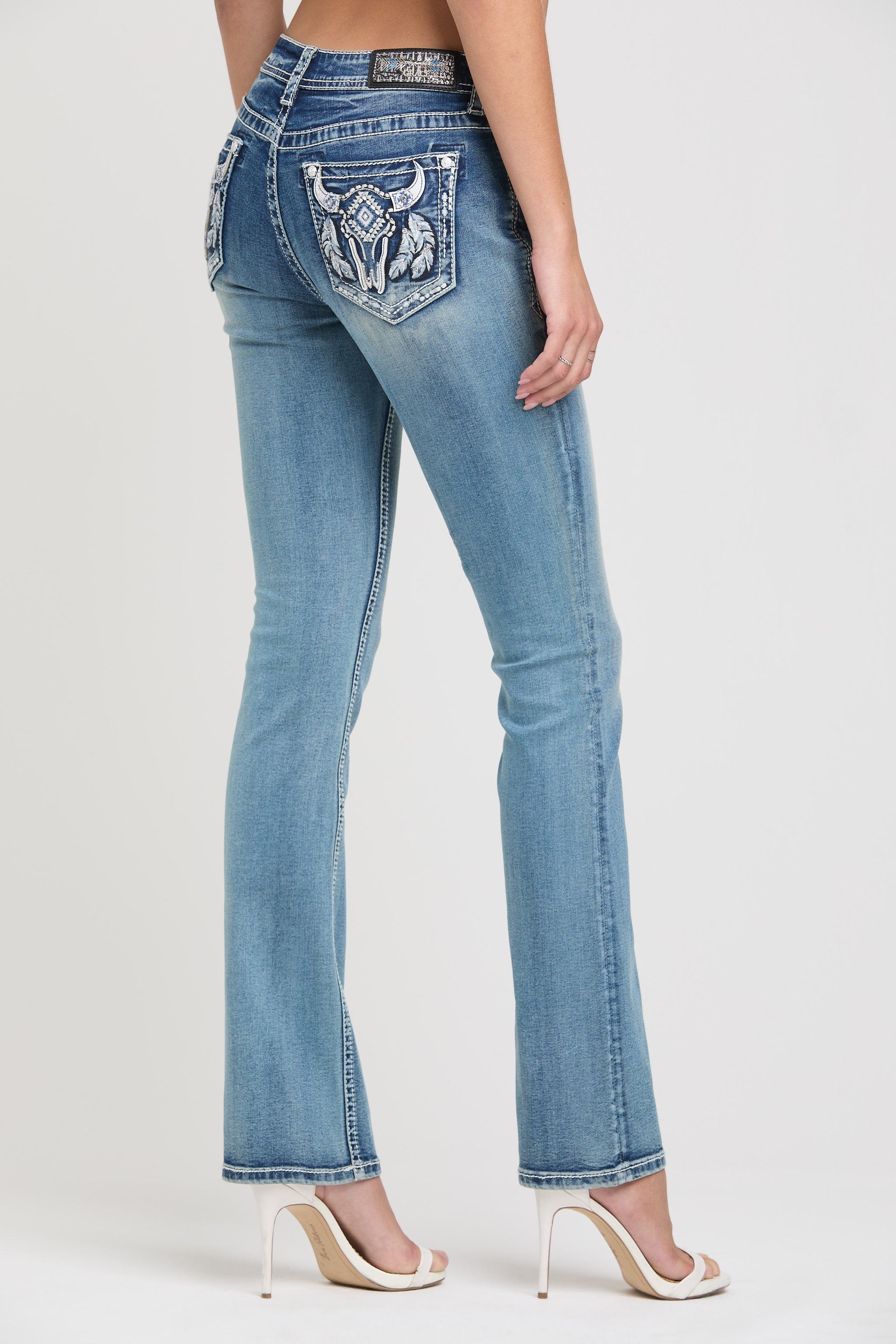 Grace in LA womens bootcut jeans in a light featuring western-inspired steer head pocket embroidery, cowgirl aesthetic rhinestone details, and a low rise fit.