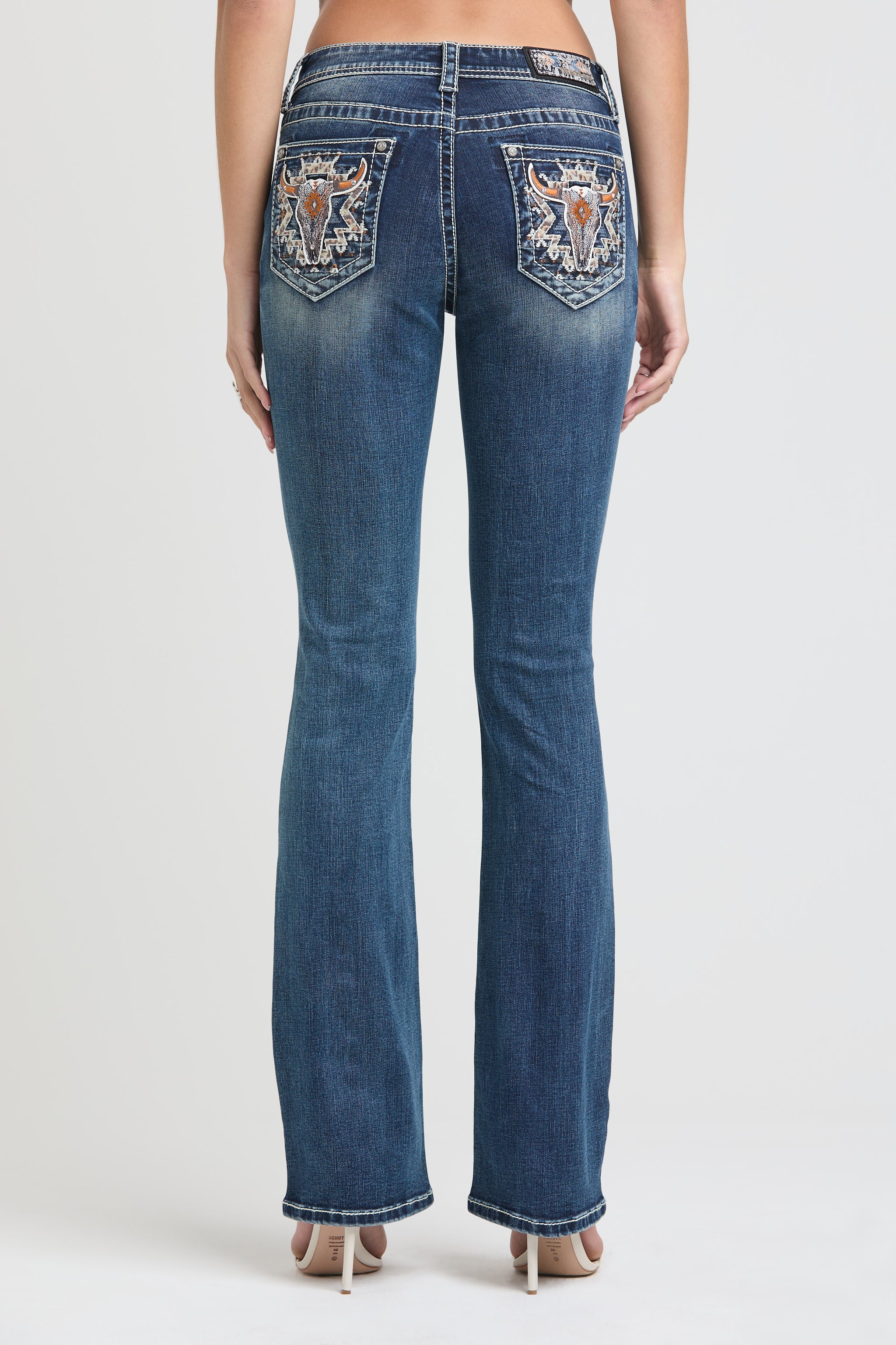 Grace in LA womens bootcut jeans featuring vertical silver lace-inspired embroidery along the outer side legs and a classic five-pocket design.