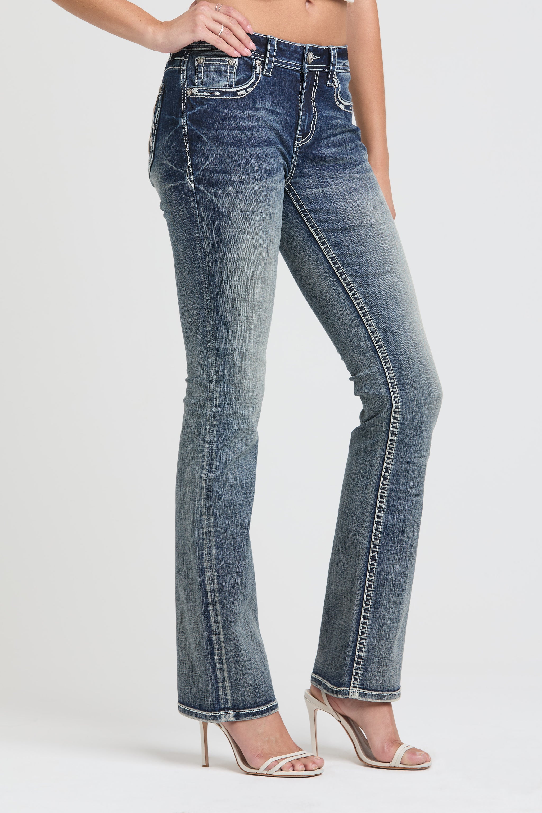 Grace in LA Women's Western Bootcut Jeans - Side View of Medium Wash Denim with Intricate Pocket Stitching and Distressed Texture
