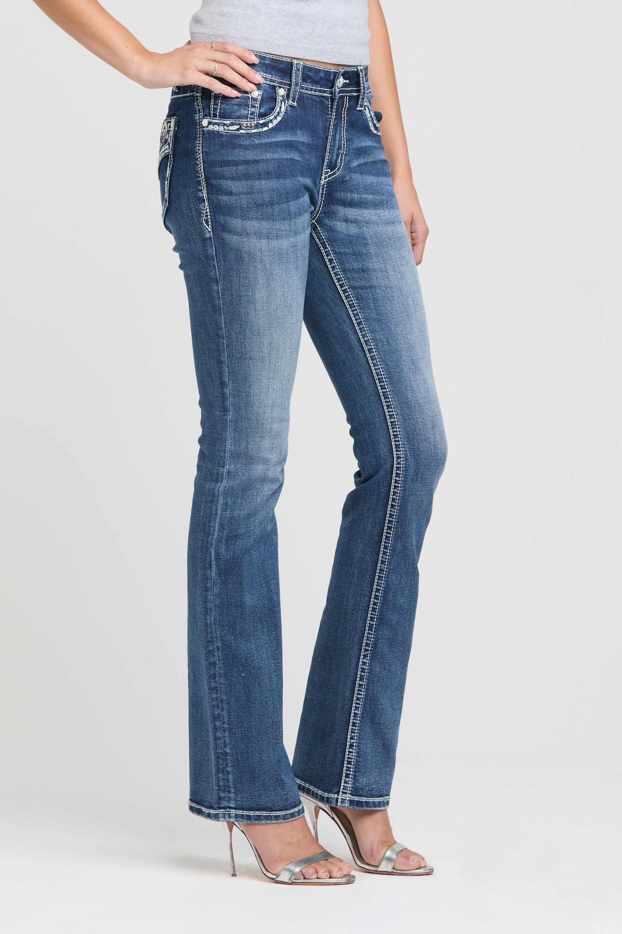 Grace in LA western embroidered jeans with rhinestone bull and star back pocket detail.