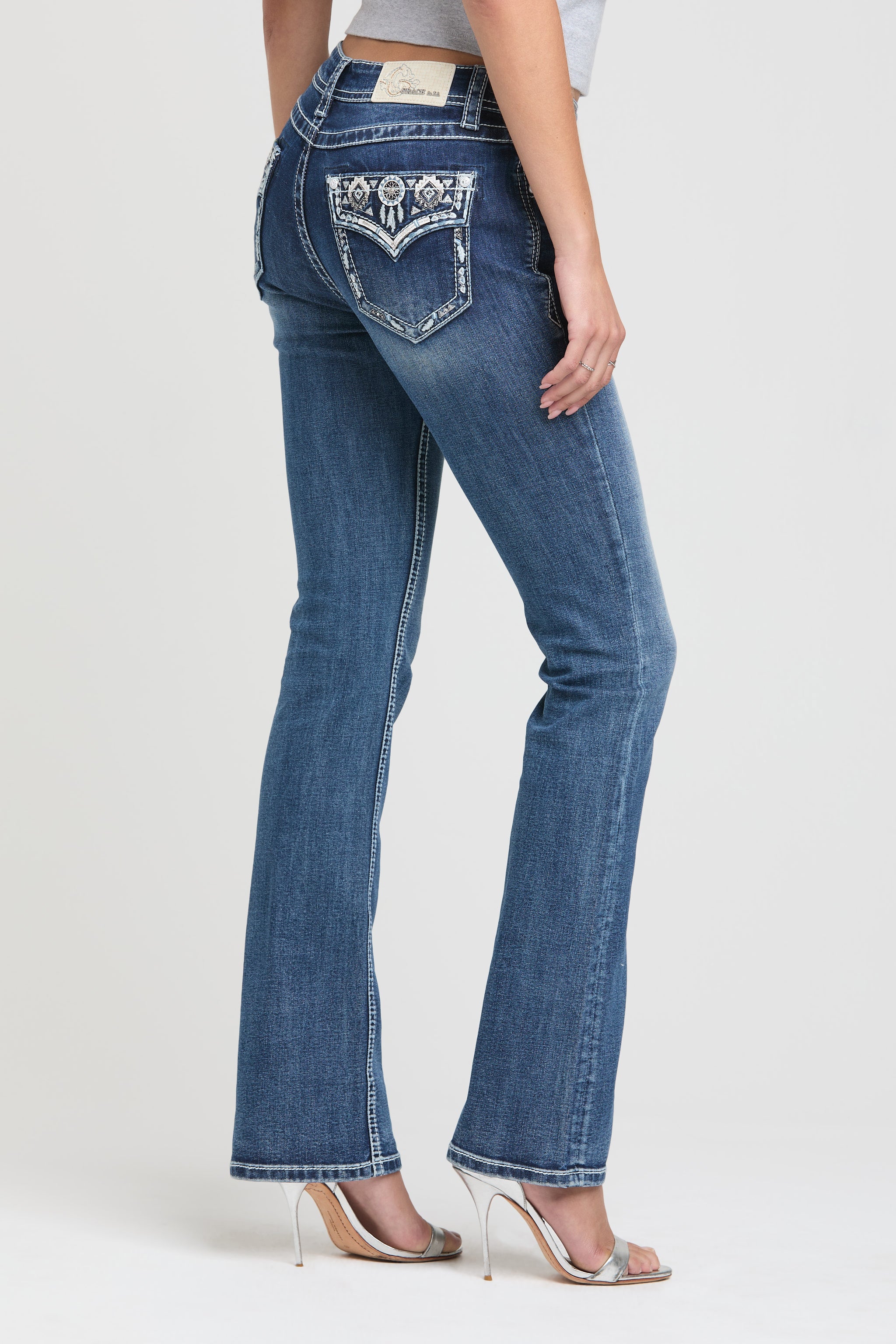 Grace in LA womens bootcut jeans in a medium wash with western rhinestone chevron back pocket design.