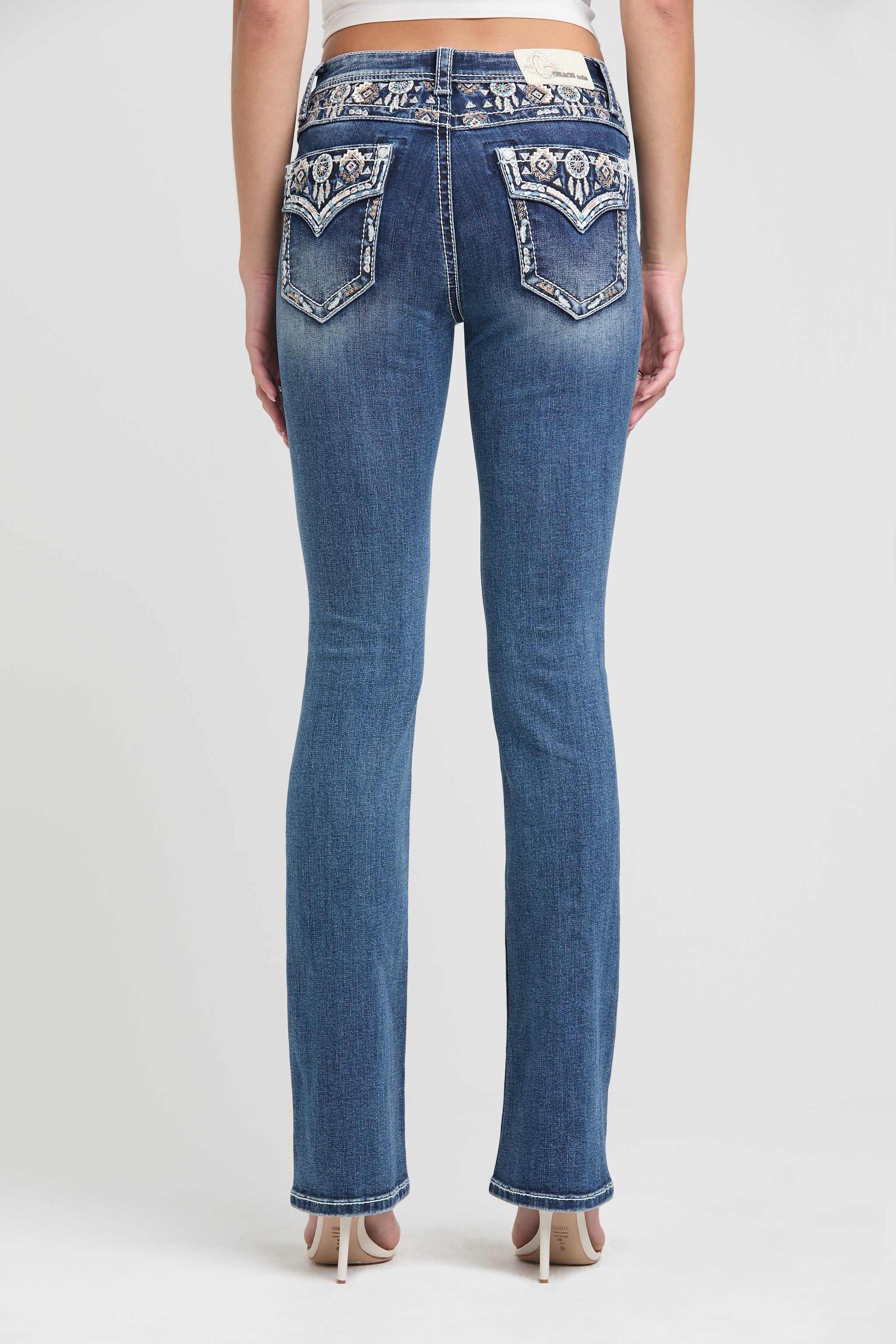 Grace in LA Women's Western Jeans - Full Back View of Slim Fit Denim with Dreamcatcher Embroidery and Aztec Patterned Pockets