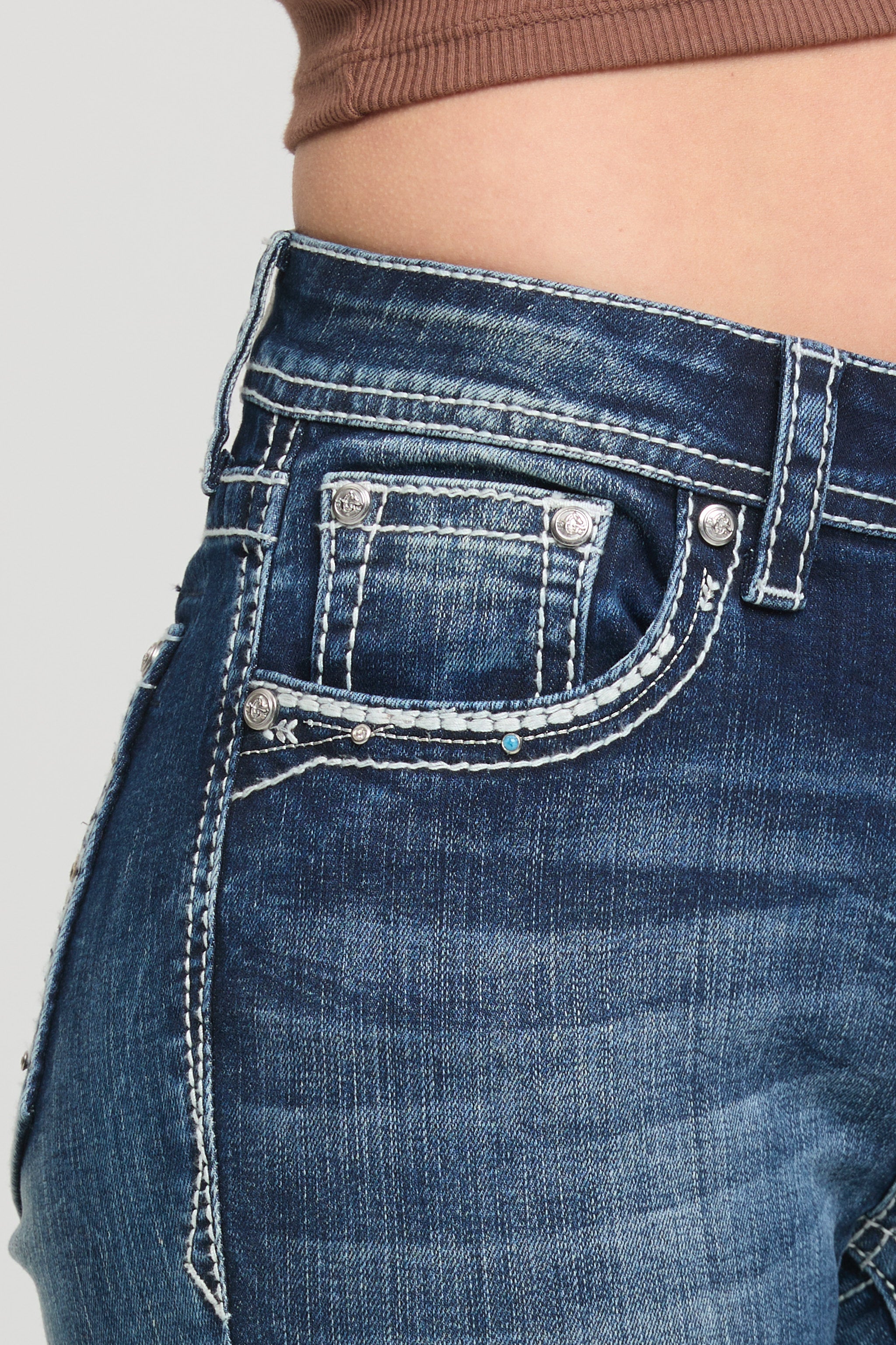 Grace in LA women’s low rise bootcut jeans medium wash front pocket close up with contrast stitching and stretch denim detail