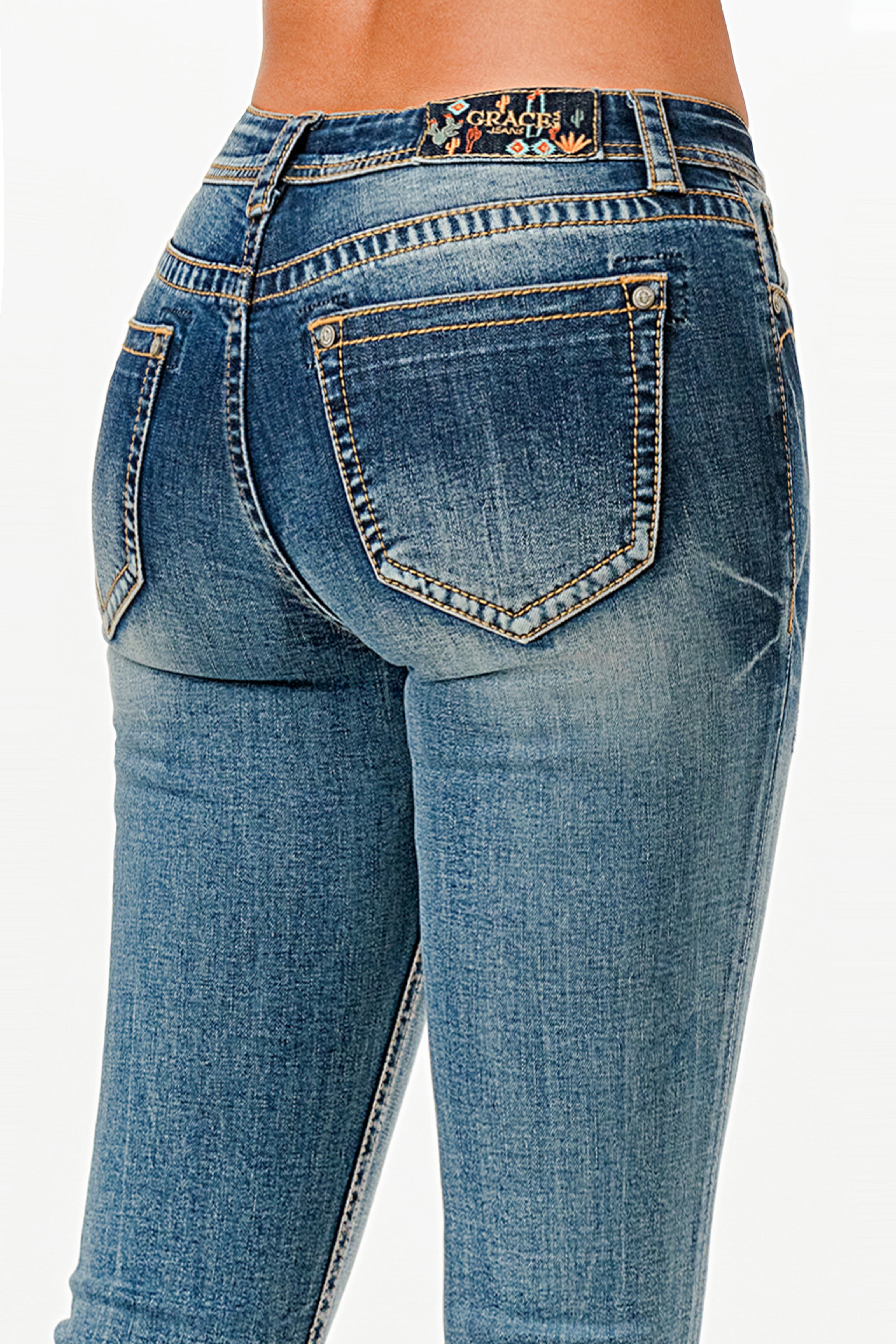 Grace in LA womens bootcut jeans in a dark wash featuring orange western stitching on the back pockets and a colorful cactus logo patch.
