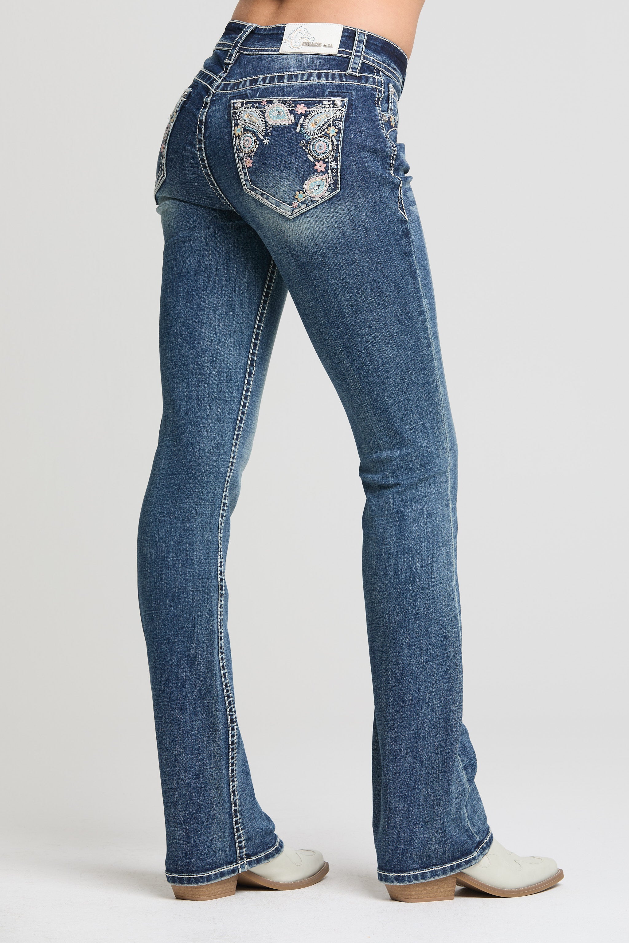 Grace in LA women’s dark wash bootcut jeans with floral embroidered back pockets angled view
