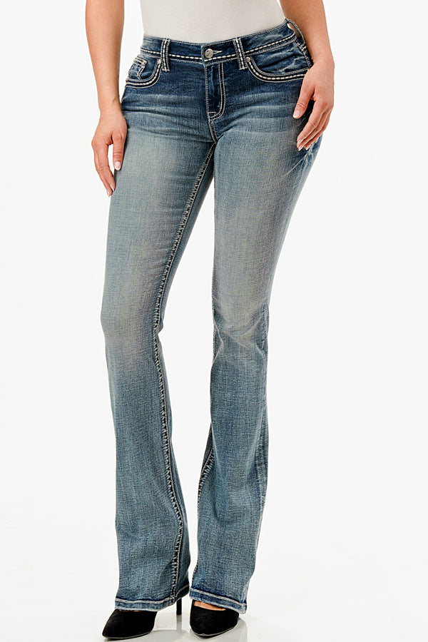 Grace in LA embroidered jeans women featuring a large silver fleur-de-lis motif with a blue geometric center and crystal rhinestone accents on the back pocket.