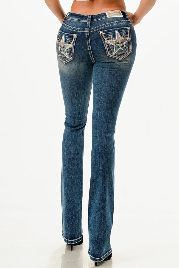 Grace in LA western jeans for women in a dark wash featuring large embroidered stars with desert-themed cactus and floral details on the back pockets.