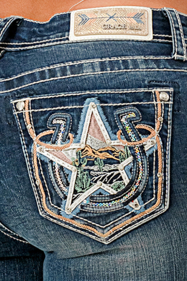 Grace in LA western jeans for women in a dark wash featuring a back pocket with a large embroidered star, desert landscape scene, and horseshoe details.