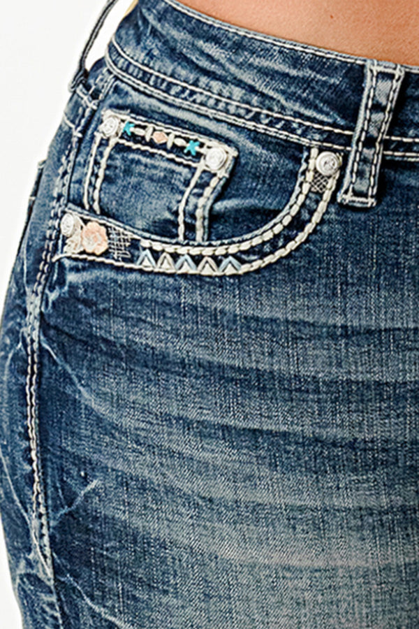 Grace in LA womens bootcut jeans close-up featuring white desert-inspired embroidery and floral accents on the front hip pocket.
