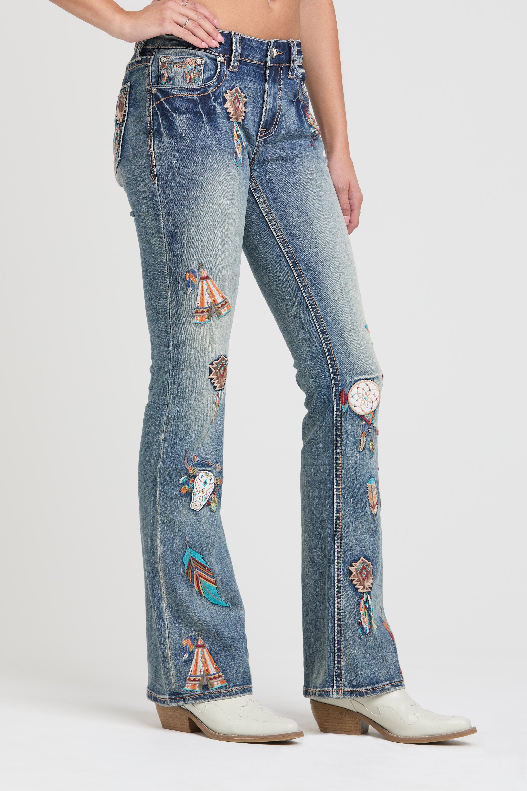Grace in LA rhinestone jeans for women featuring colorful geometric tribal embroidery with crystal studs on the back pocket and waistband.