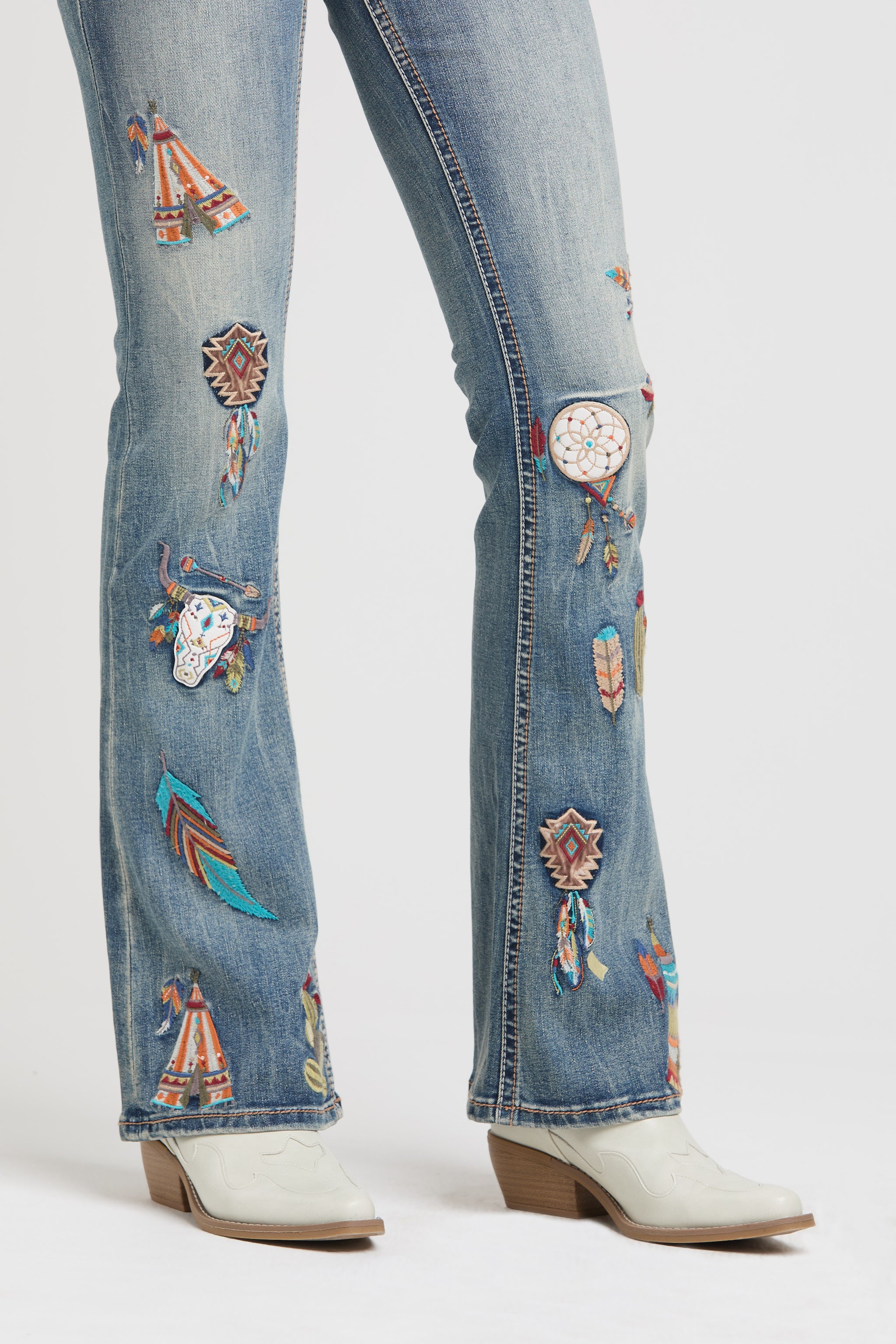 Grace in LA womens flare jeans with colorful western patches including dreamcatchers and feathers.