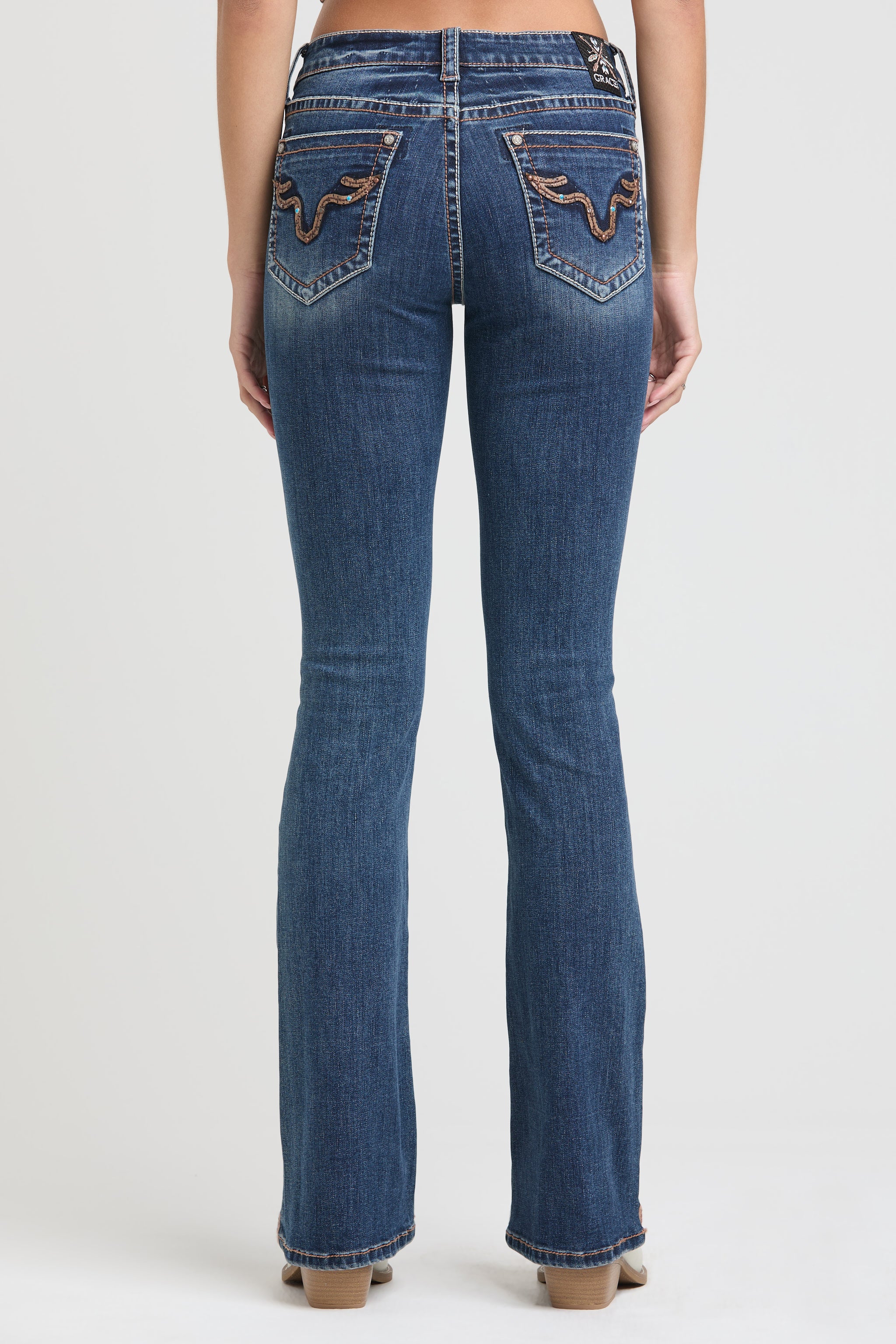 Grace in LA rhinestone jeans for women featuring crystal embellished front pocket and silver stud detailing.
