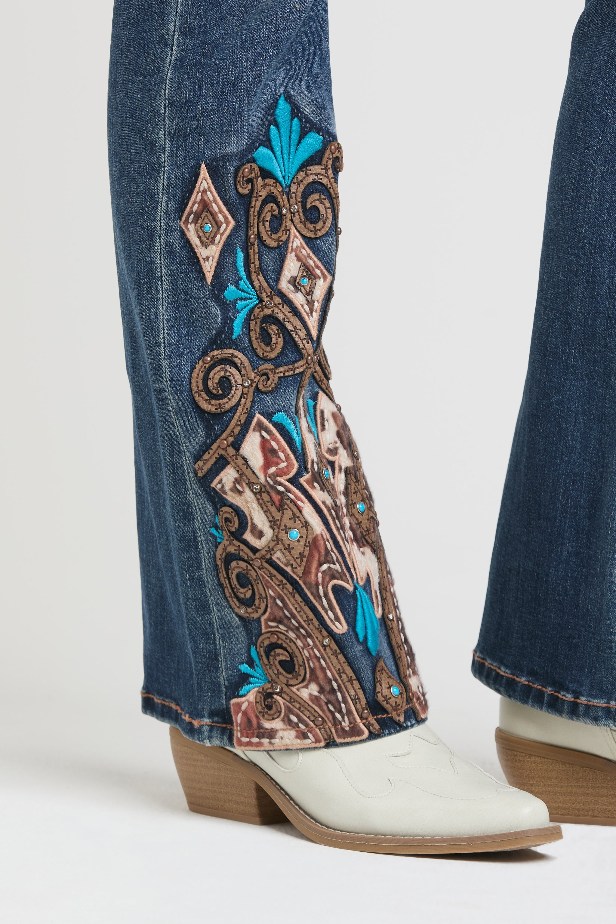 Grace in LA rhinestone jeans for women featuring crystal embellished front pockets and intricate white contrast stitching.