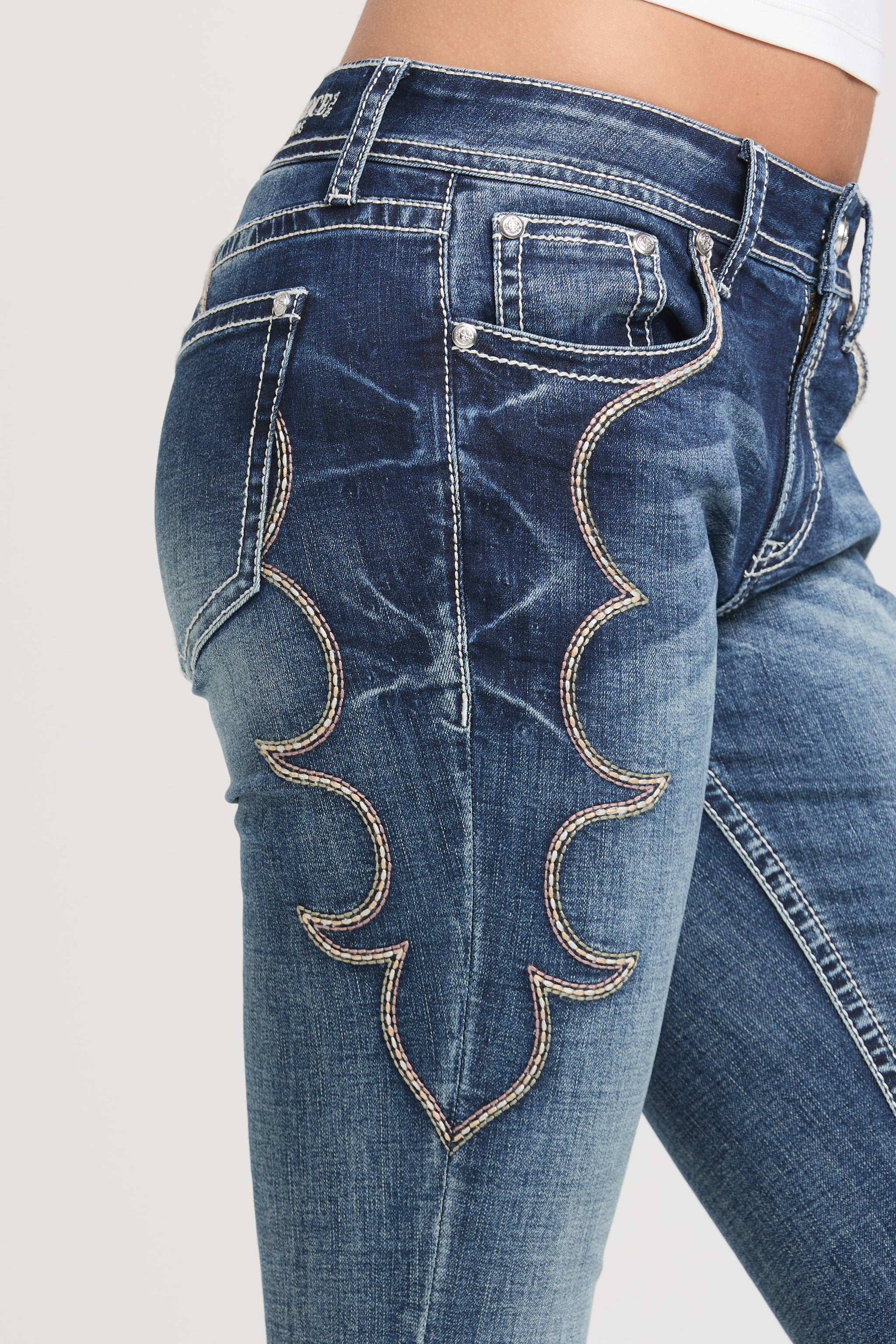 Grace in LA womens bootcut jeans with large western embroidered scroll patterns on the side hip and thigh.