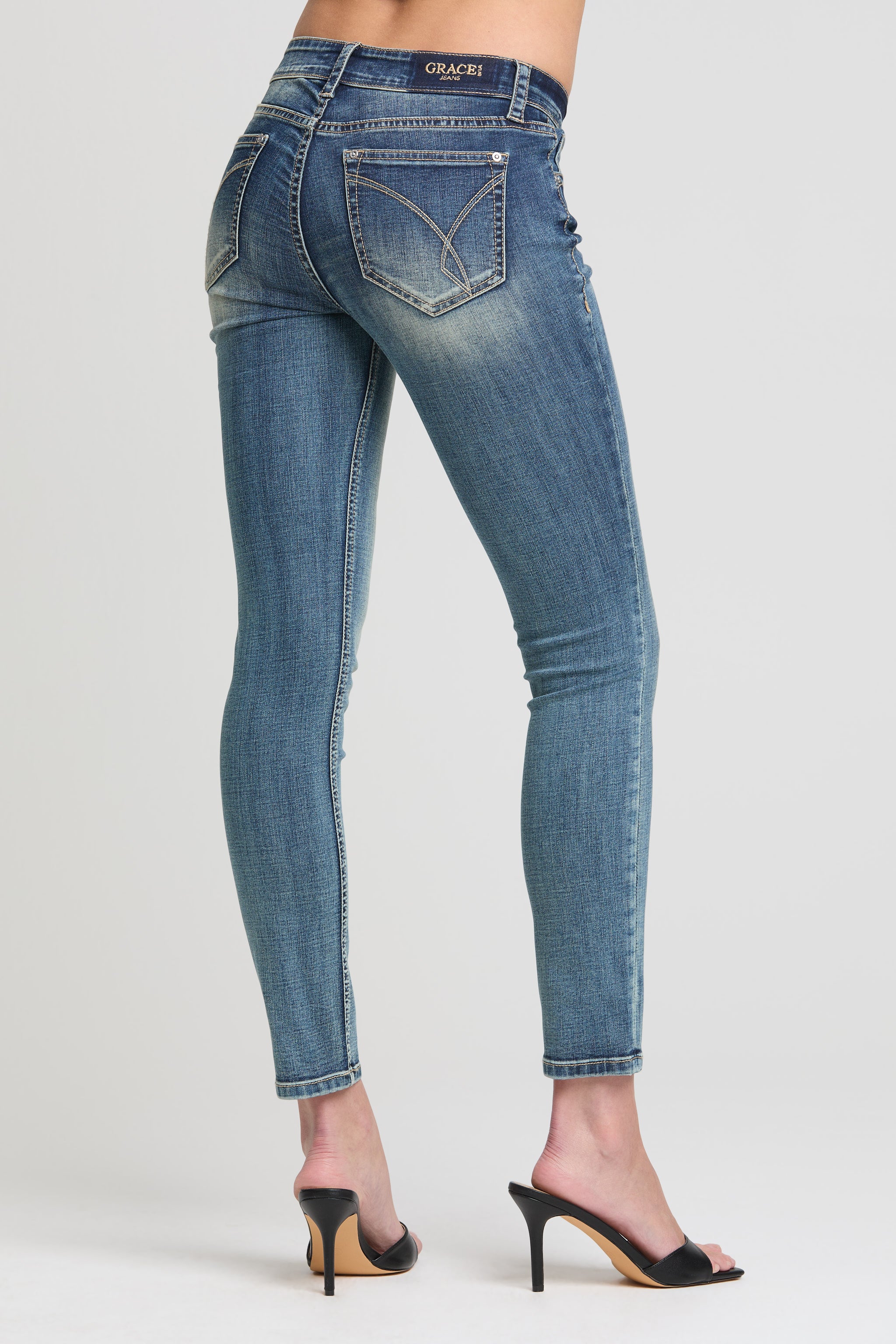 Grace in LA women’s skinny ankle jeans low rise medium wash back view with signature stitched pockets
