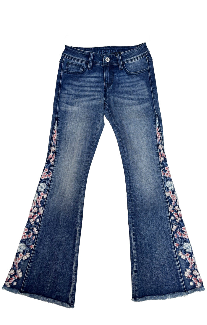 Grace in LA womens flare jeans with colorful floral embroidery accents along the side seams and a raw fringe hem.