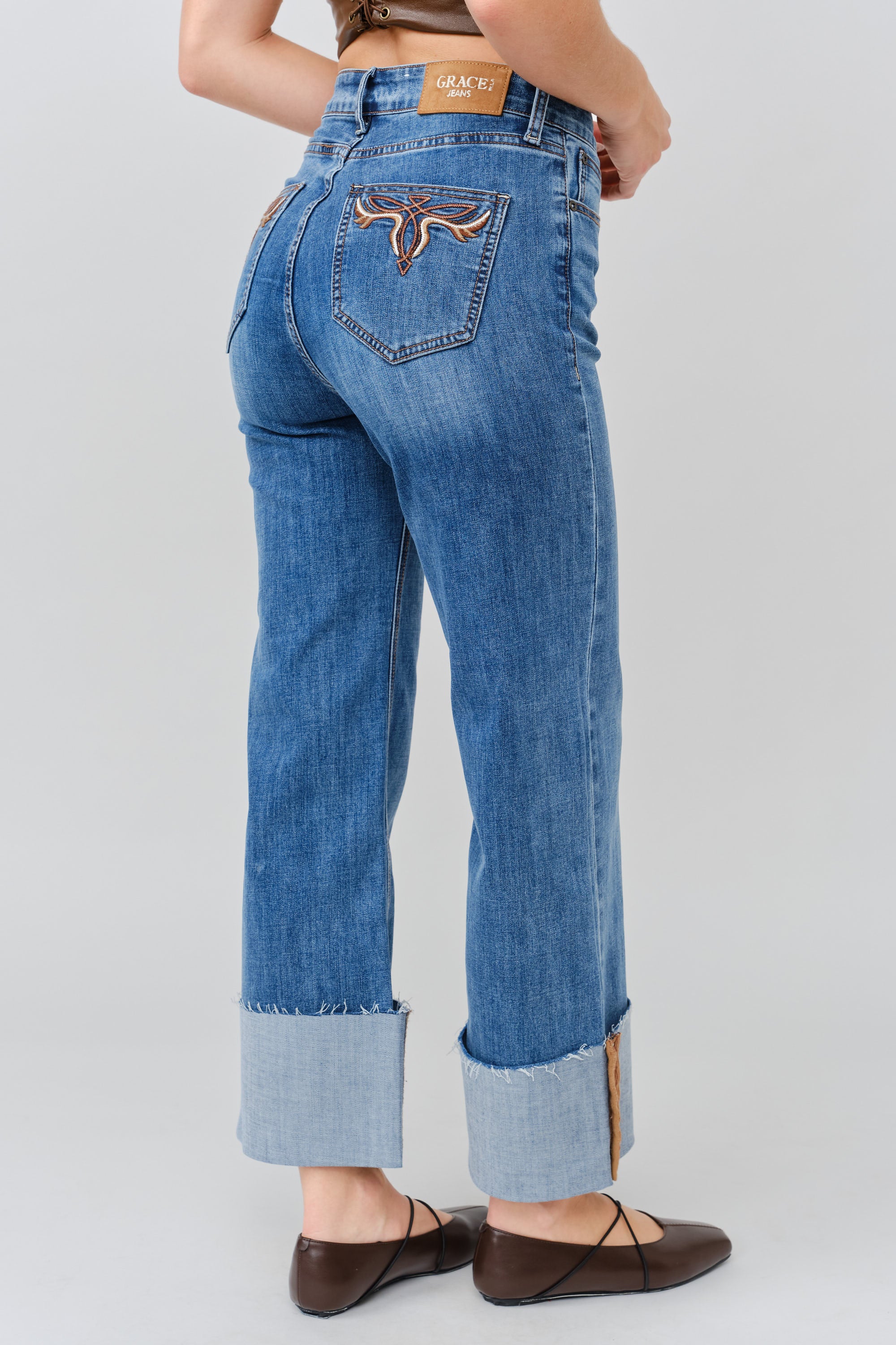 Grace in LA women's medium wash flare jeans, side-facing view with a fitted hip and flared leg