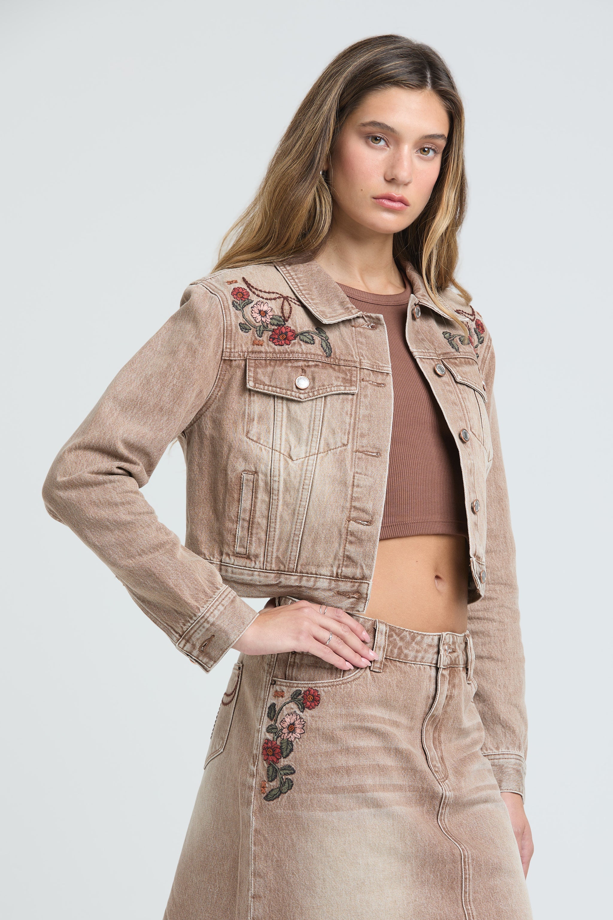 Grace in LA womens denim jacket in tan featuring western-inspired red floral embroidery, cowgirl aesthetic rhinestone details, and a cropped fit.