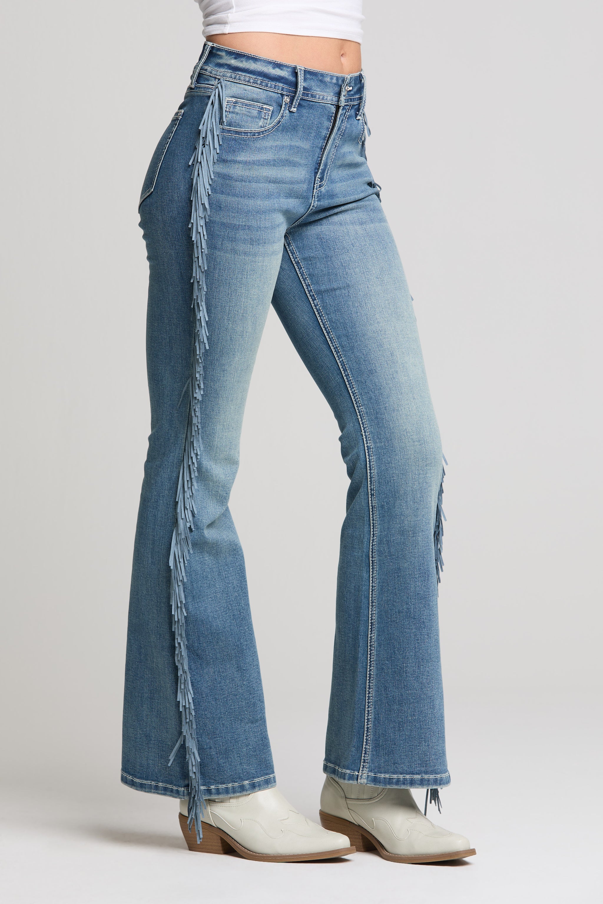 Grace in LA women’s medium wash flare jeans with long side fringe detail