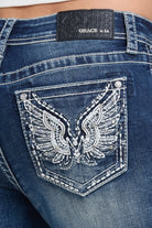 Grace in LA women's medium wash bootcut jeans in a slim western silhouette with wing embroidery