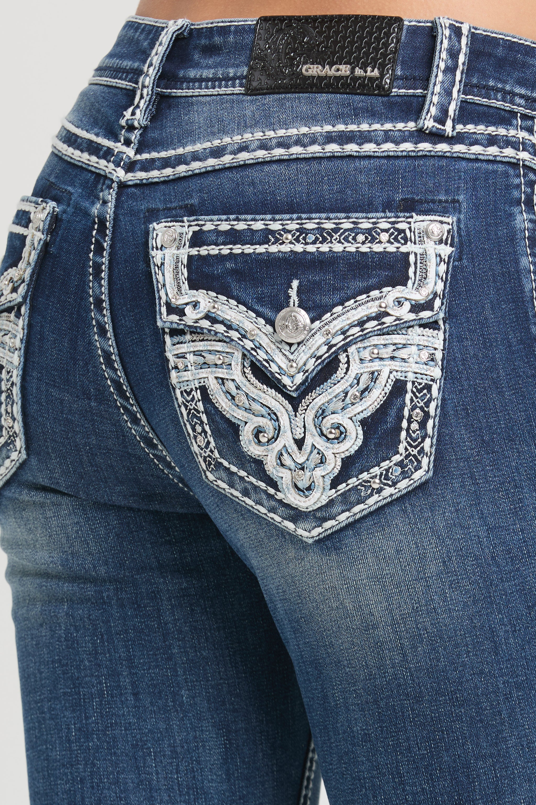 Grace in LA rhinestone jeans women featuring western embroidered flap pockets with crystal embellishments on dark denim.