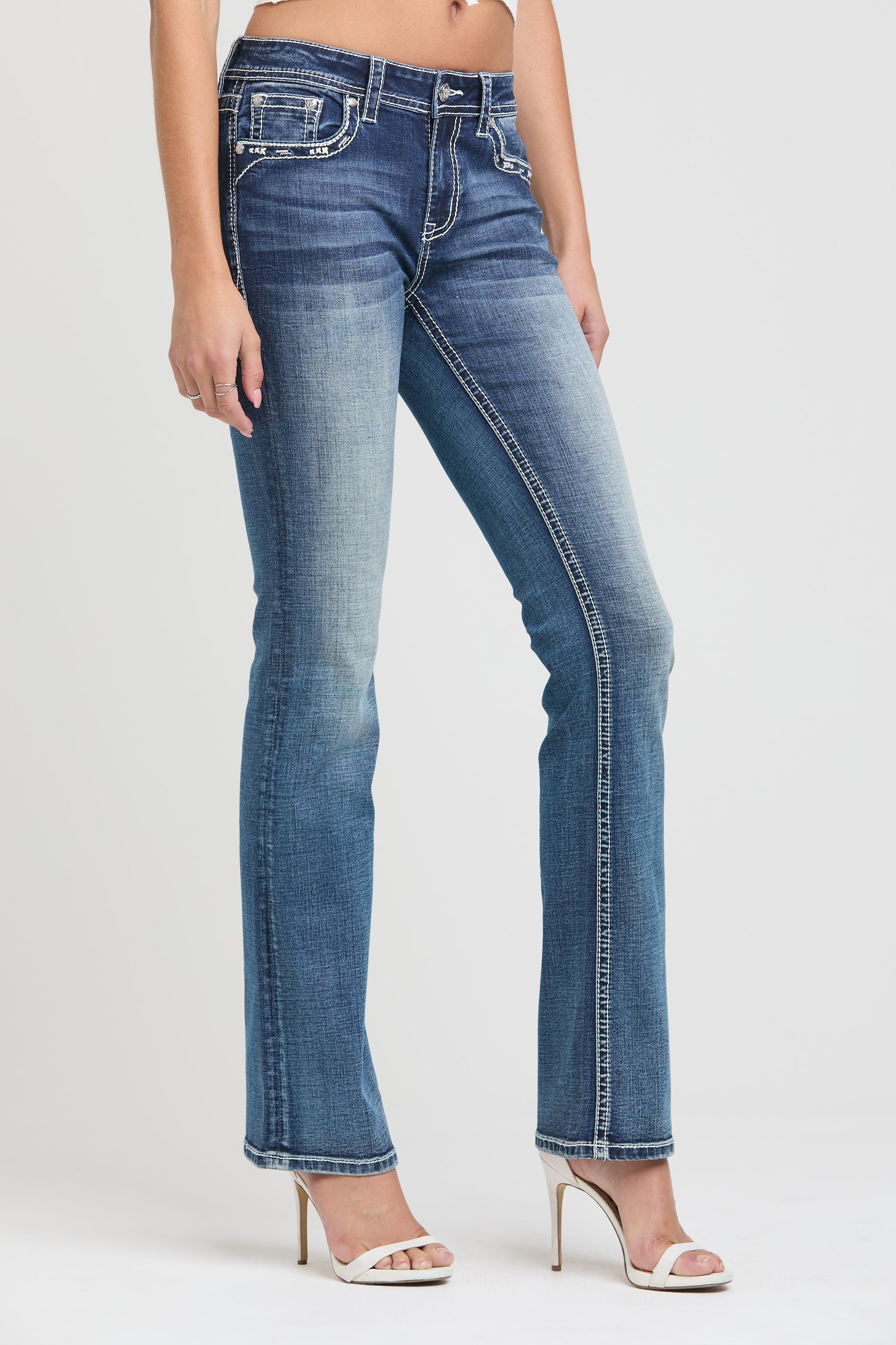 Grace in LA rhinestone jeans for women featuring heavy white contrast stitching and crystal embellished pocket detailing.