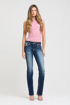Grace in LA embroidered jeans women featuring a western horseshoe motif on the back pocket with intricate tribal star patterns and metallic silver stitching.