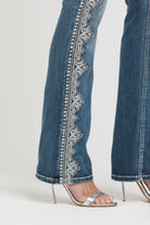Grace in LA embroidered jeans women featuring intricate silver baroque scrollwork and metallic stitching along the side outer seam.