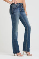 Grace in LA embroidered jeans women featuring a western longhorn bull skull with orange horns and an intricate geometric tribal sunburst on the back pocket.