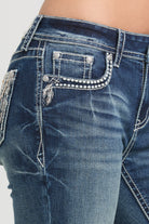 Grace in LA embroidered jeans women featuring a classic denim coin pocket with white western zig-zag stitching and a single feather motif.