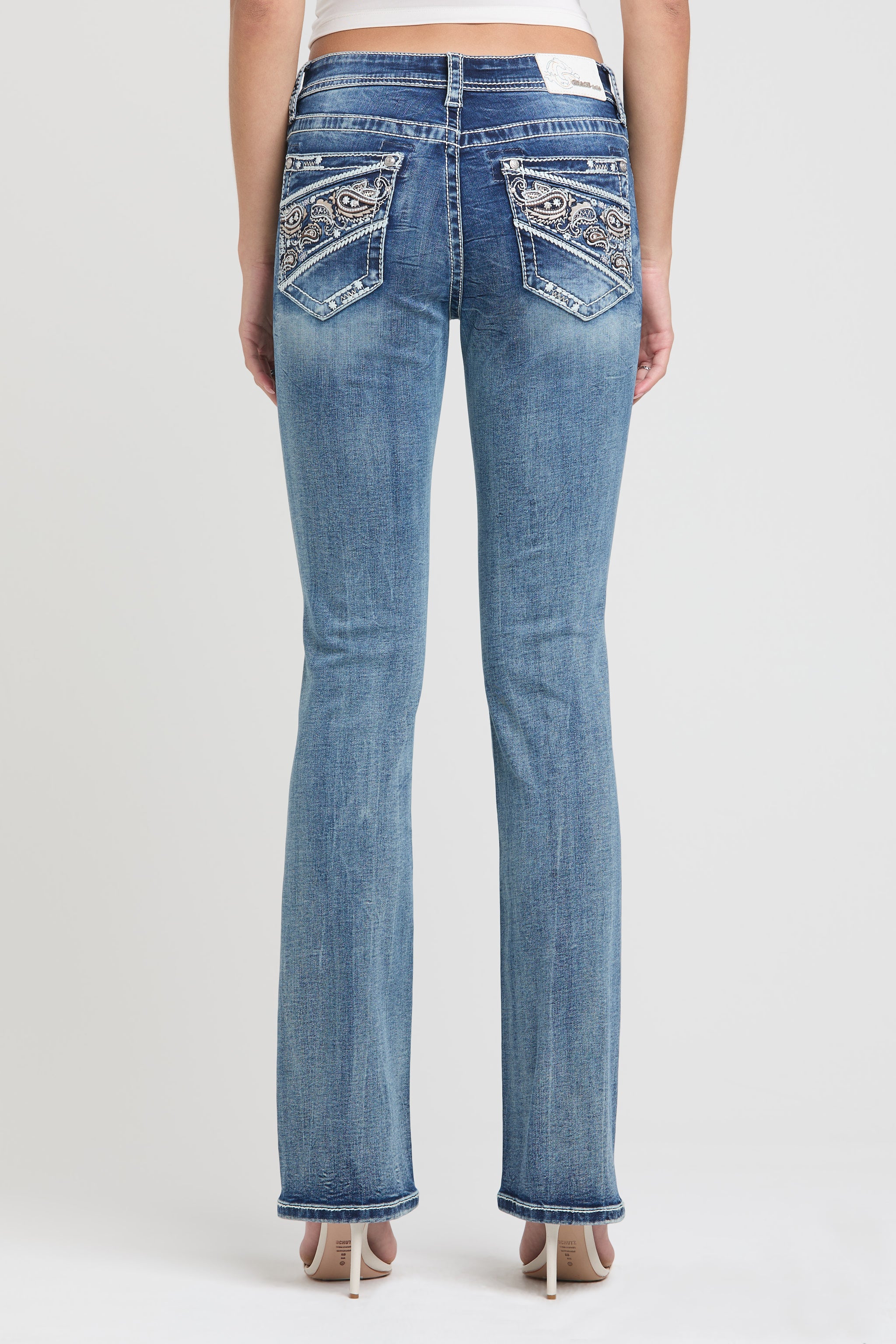 Grace in LA embroidered jeans women featuring a western paisley motif in neutral earth tones with metallic silver accents and crystal rhinestone.