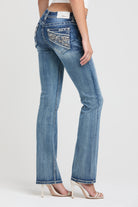 Grace in LA embroidered jeans women featuring a western paisley design with a mix of neutral and metallic stitching on the back pocket.