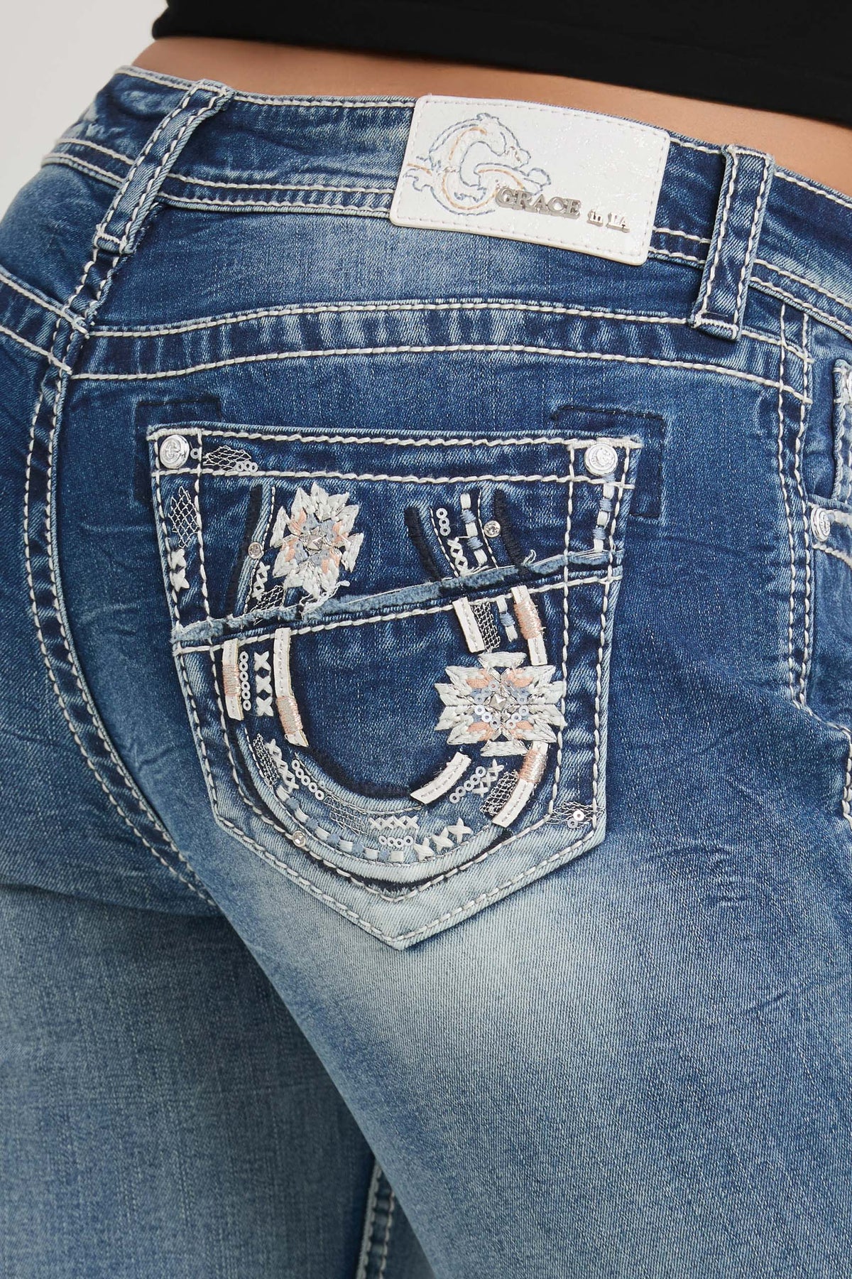 Grace in LA bootcut jeans back pocket detail featuring horse shoe and floral embroidery