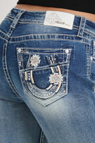 Grace in LA bootcut jeans back pocket detail featuring horse shoe and floral embroidery