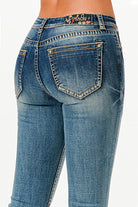 Grace in LA womens bootcut jeans in a dark wash featuring orange western stitching on the back pockets and a colorful cactus logo patch.