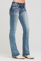 Grace in LA women's medium light wash bootcut jeans styled for a western-inspired look
