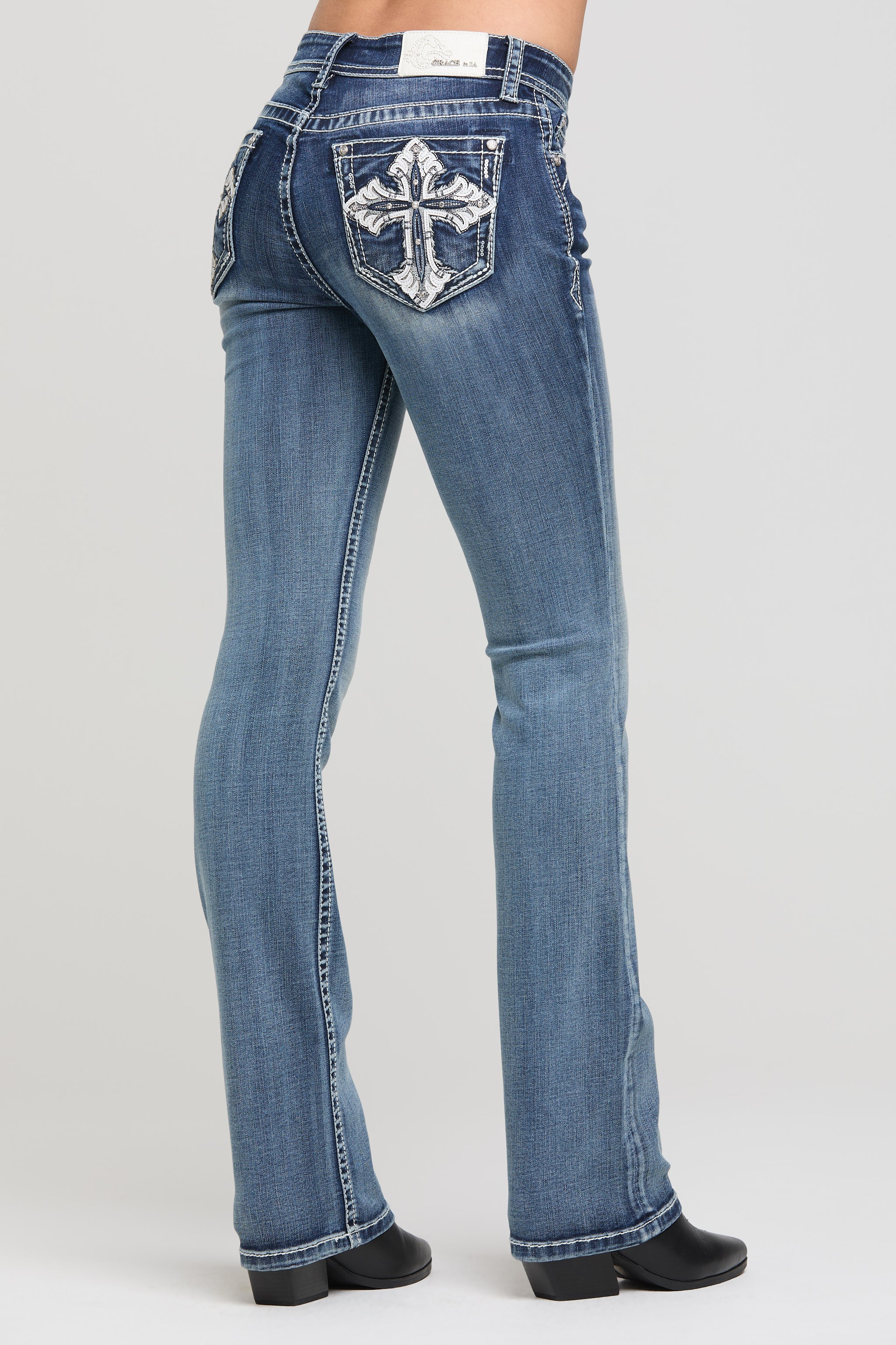 Grace in LA Women's Bootcut Jeans with Large White Embroidered Cross on Back Pockets - Side View Western Denim