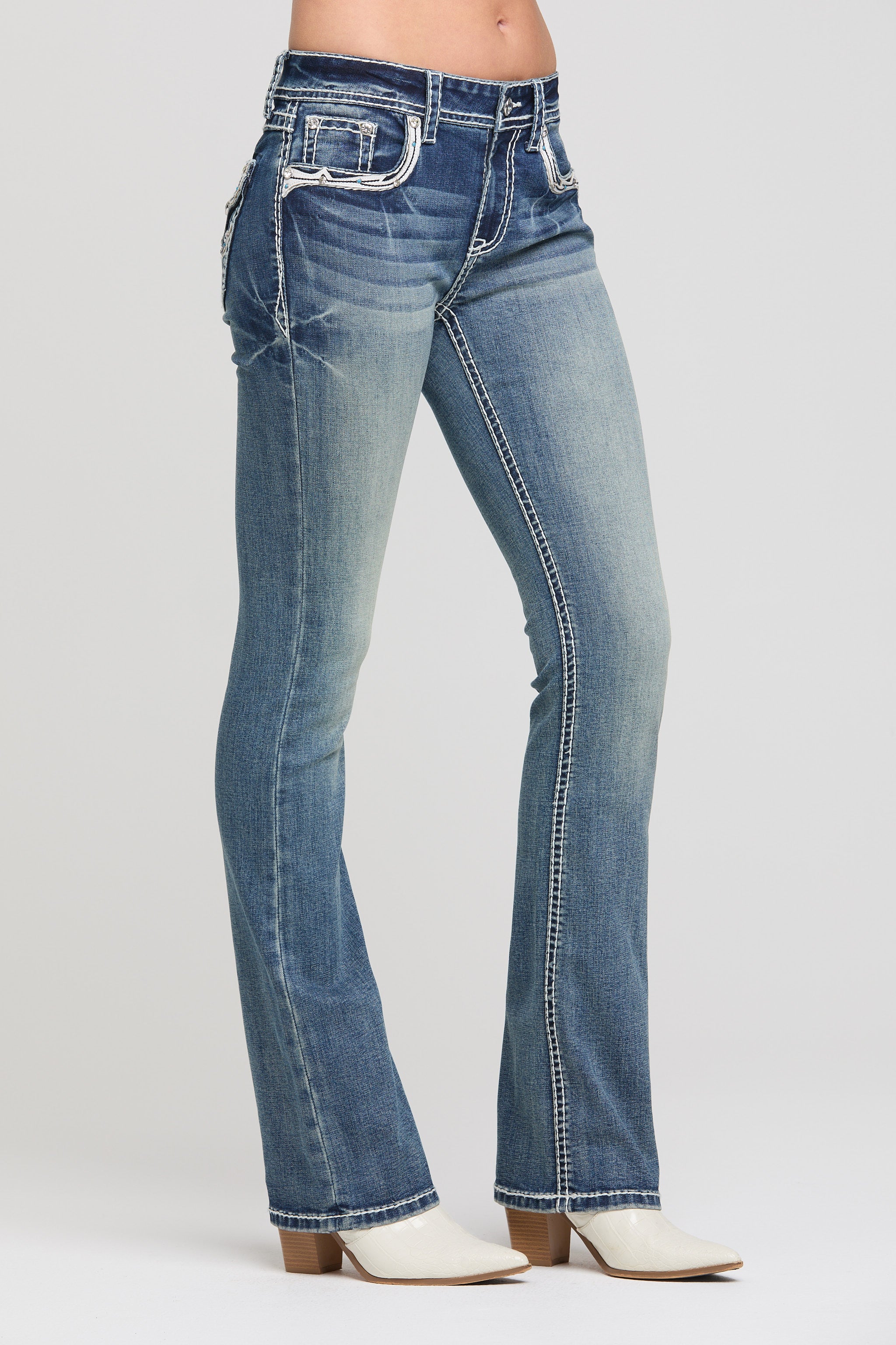 Grace in LA women's medium wash bootcut jeans, full-length view showing the medium wash denim and bootcut leg