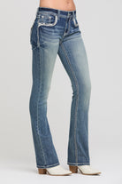Grace in LA women's medium wash bootcut jeans, full-length view showing the medium wash denim and bootcut leg